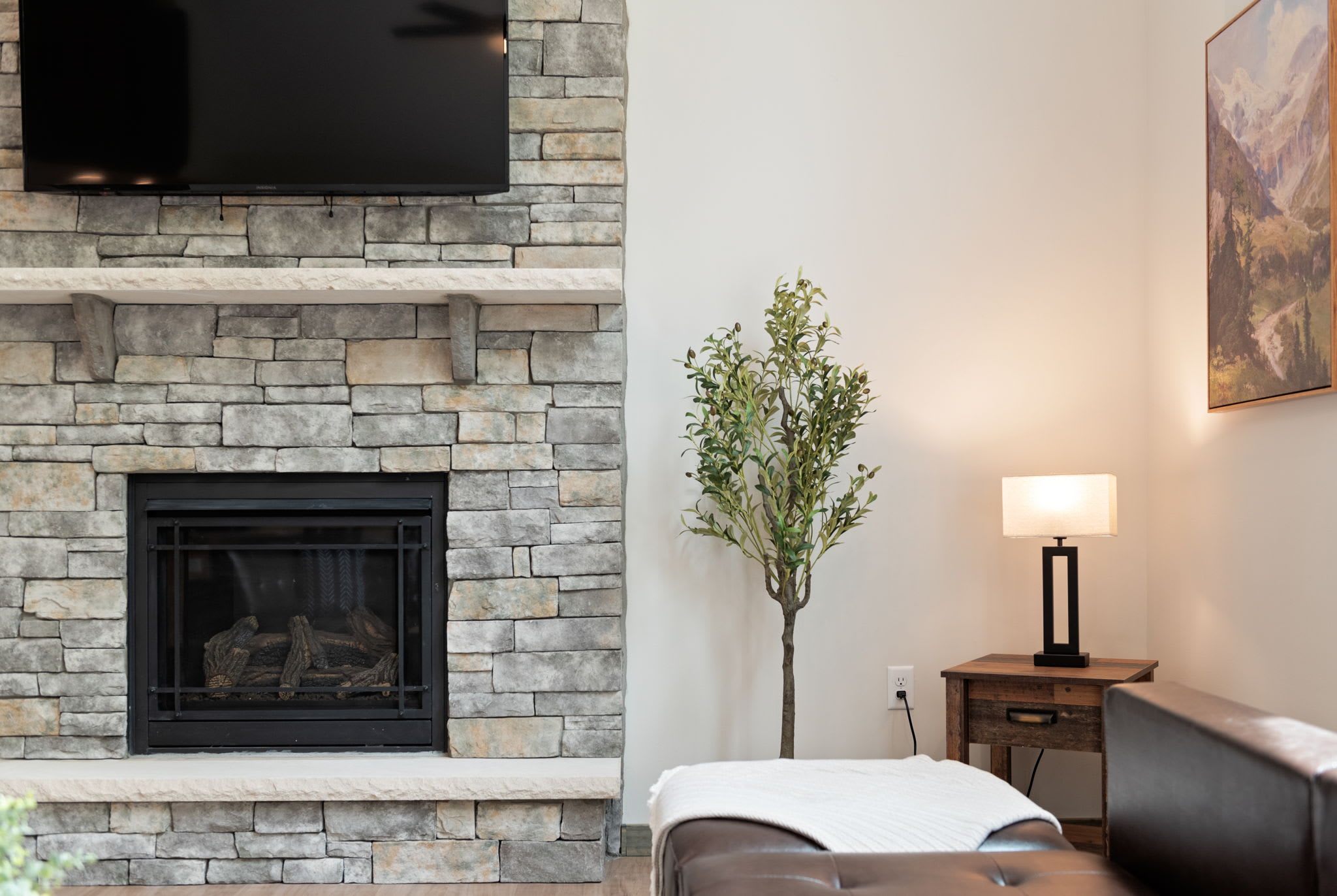 A quiet moment by the fire. This corner setup offers soft light and a warm glow for reading or relaxing.