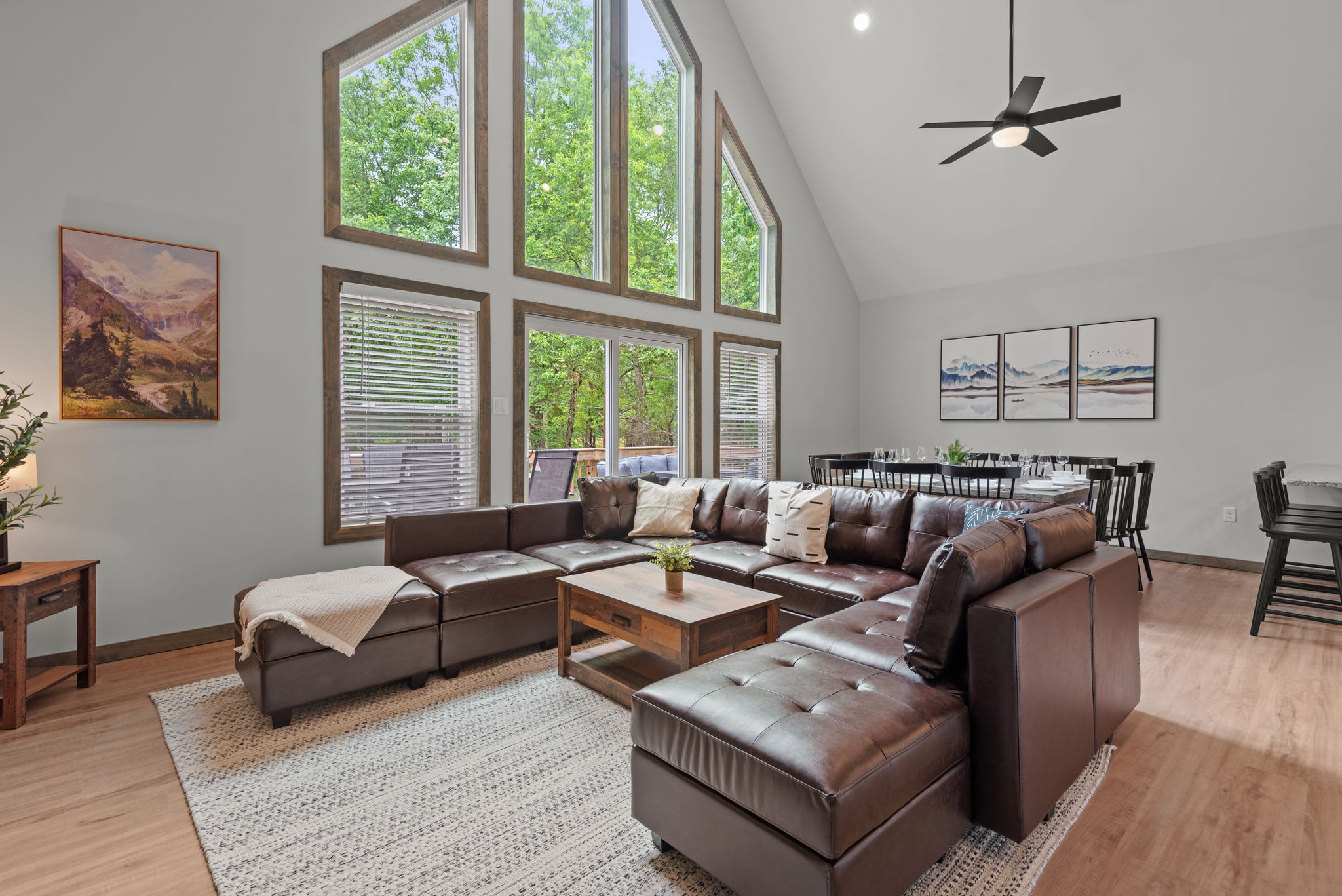 Living Room with Window Wall
This cozy lounge space is framed by tall windows that bring the outside in, with a comfy sectional perfect for relaxing or gathering as a group.