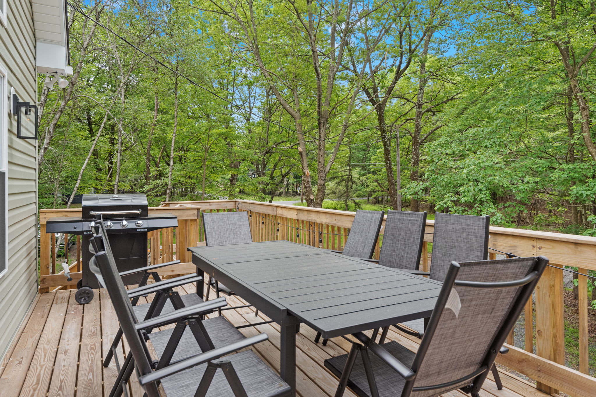 Outdoor Dining with Grill Setup
Fire up the grill and gather around. This deck dining area is surrounded by trees and perfect for meals under the open sky.