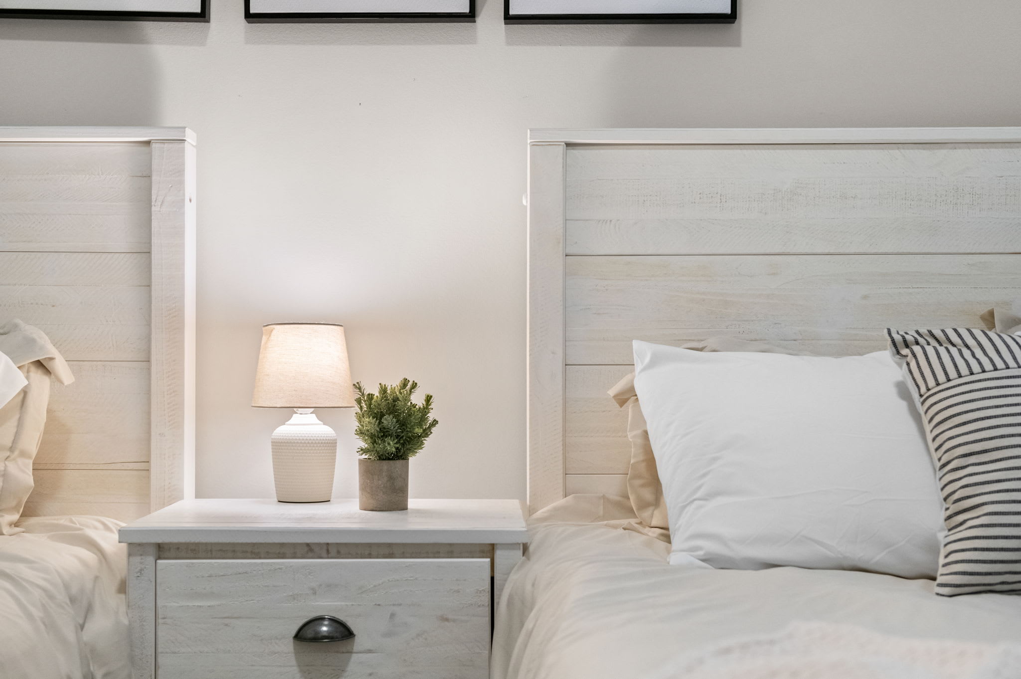 Warm whites, a touch of greenery, and ambient lighting create a calming atmosphere for winding down.