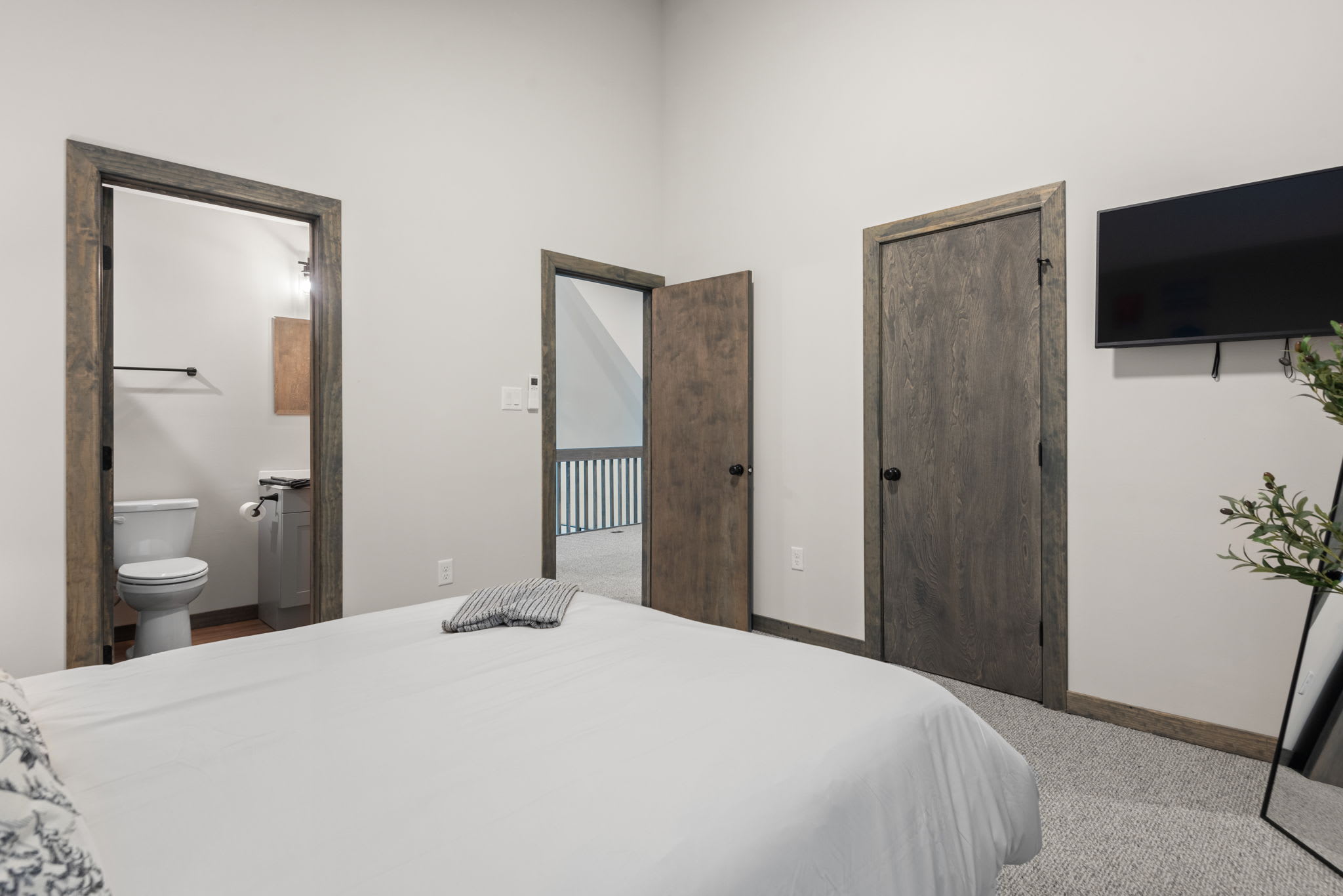 A practical layout with mounted TV and bathroom access makes this an ideal room for comfort and privacy.