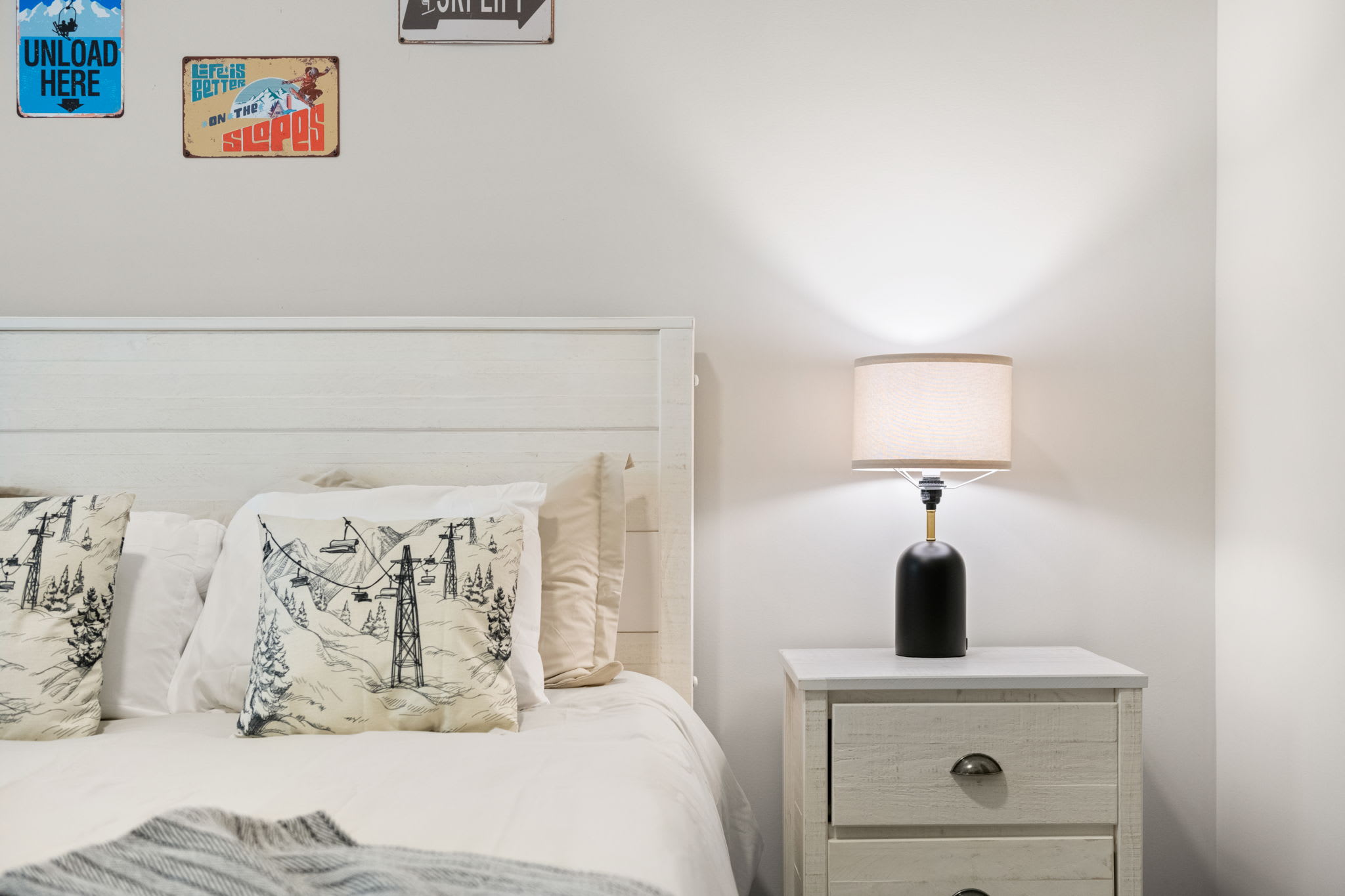 Stylish touches and cozy textures come together in this clean, modern bedroom layout with warm lighting.