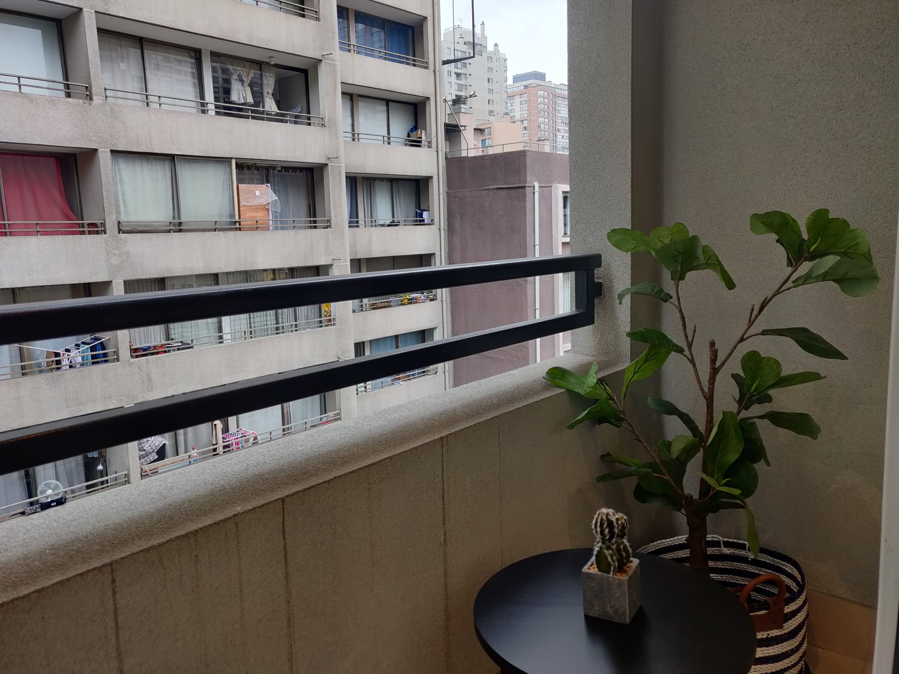 Cozy balcony retreat with city views, perfect for a morning coffee or evening relaxation.