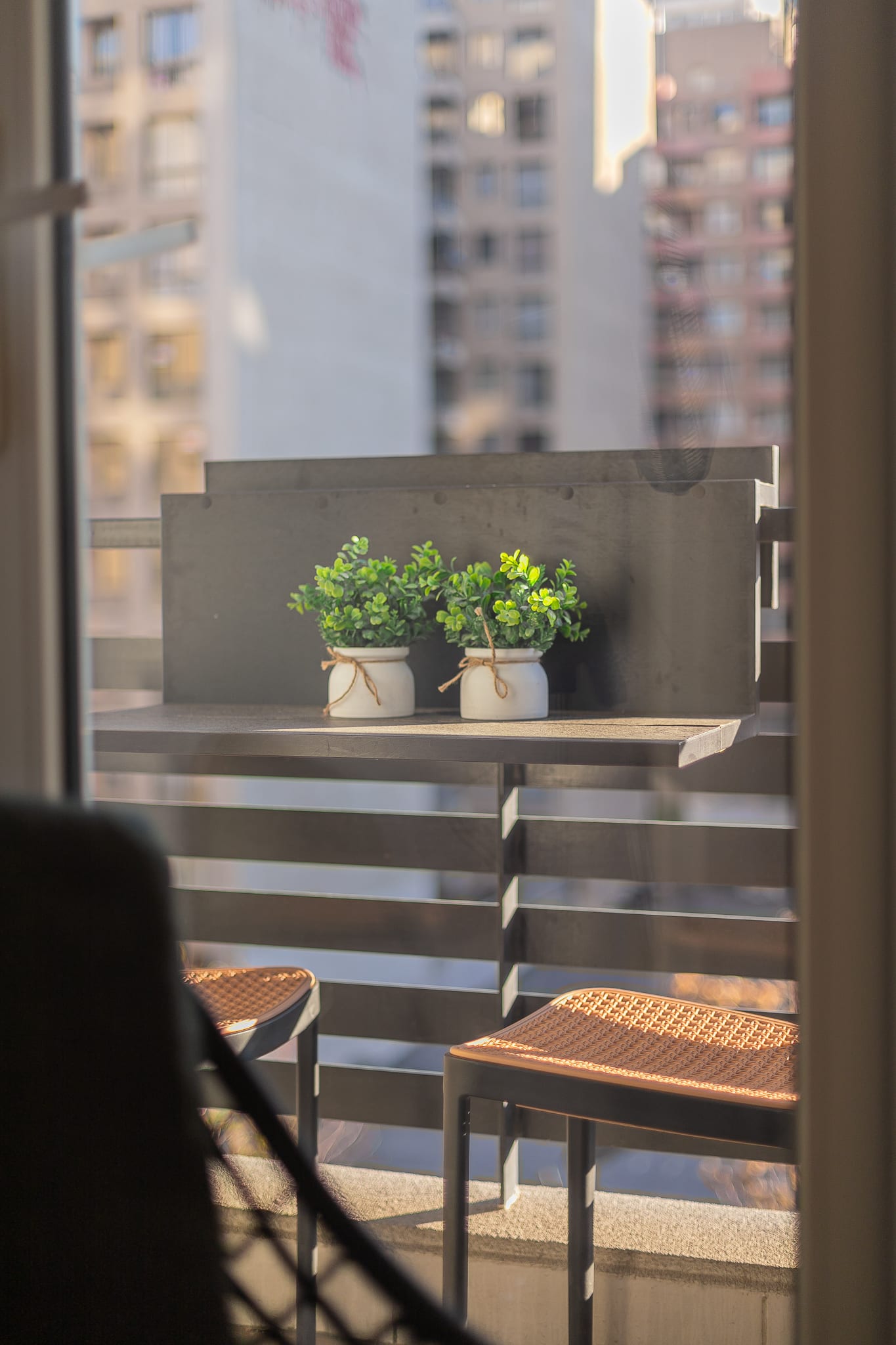 Cozy balcony with charming city views, perfect for relaxing with a morning coffee.