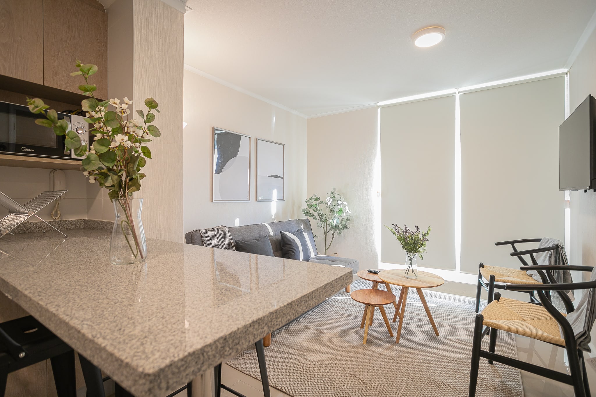 Bright and modern living area with cozy seating and stylish decor, perfect for relaxation.