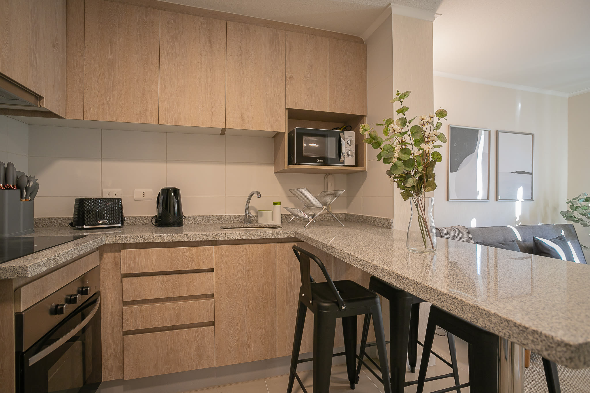 Modern and well-equipped kitchen with sleek countertops and cozy dining space, perfect for cooking and relaxing.