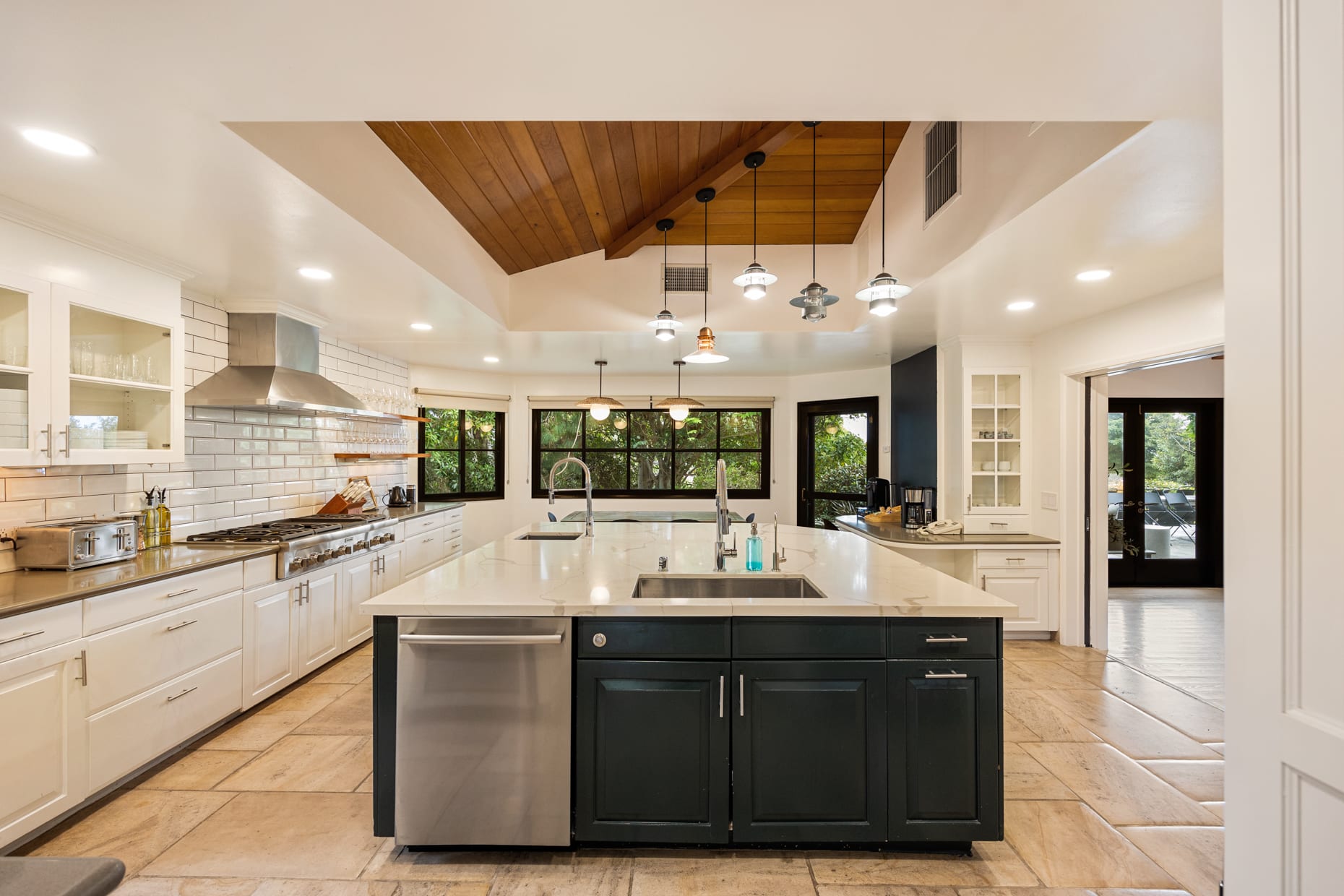 Gorgeous kitchen with a blend of dark and light tones, featuring unique wood accents that bring warmth to the home.