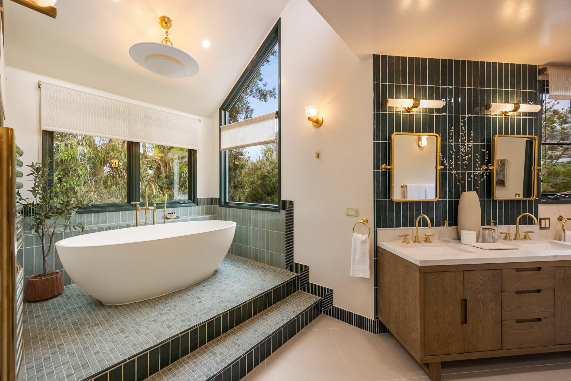 Modern design and high-end finishes create a spa-like atmosphere in the primary suite's bathroom.