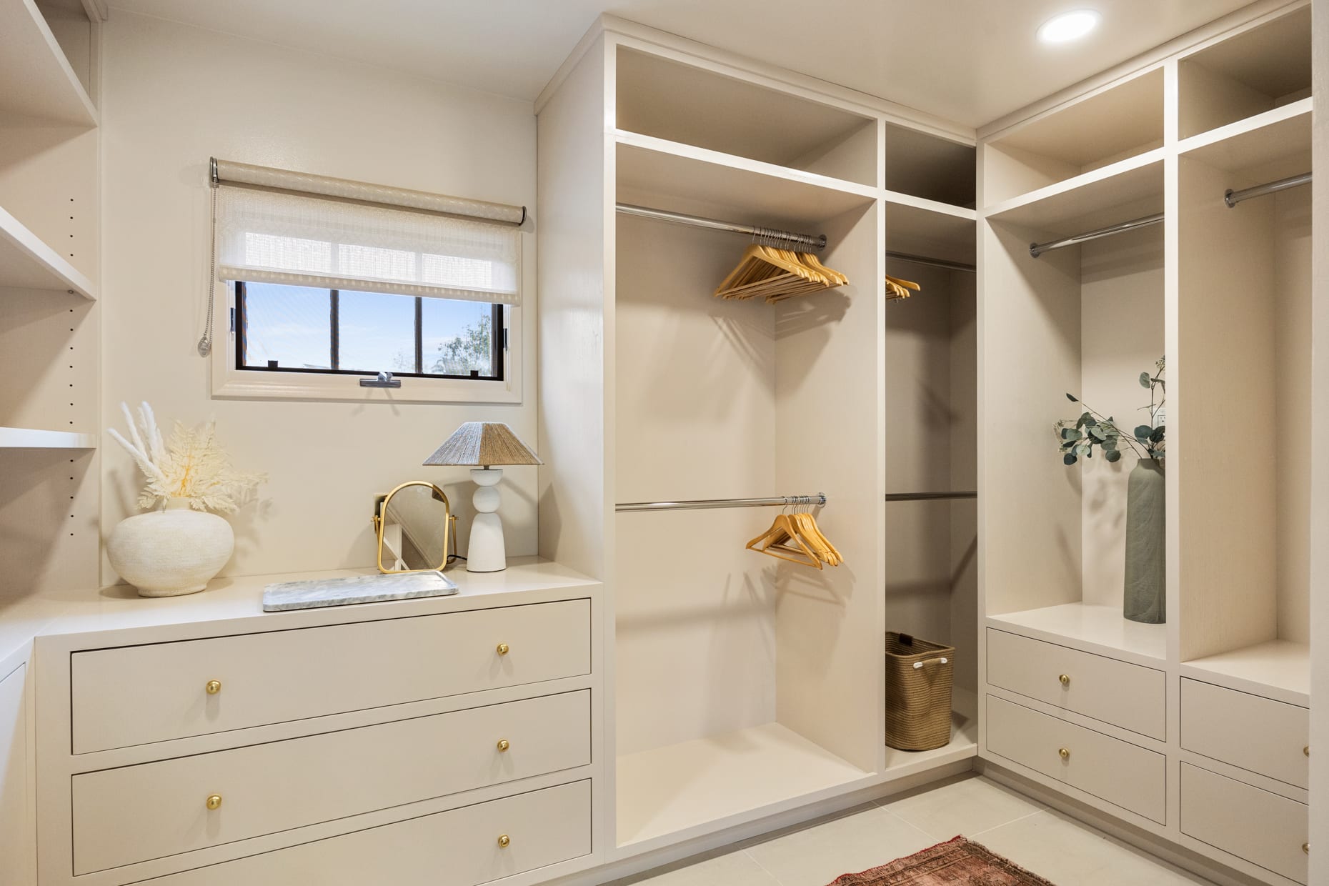 Elegant walk-in closet featuring built-in organizers and plenty of room for your wardrobe.