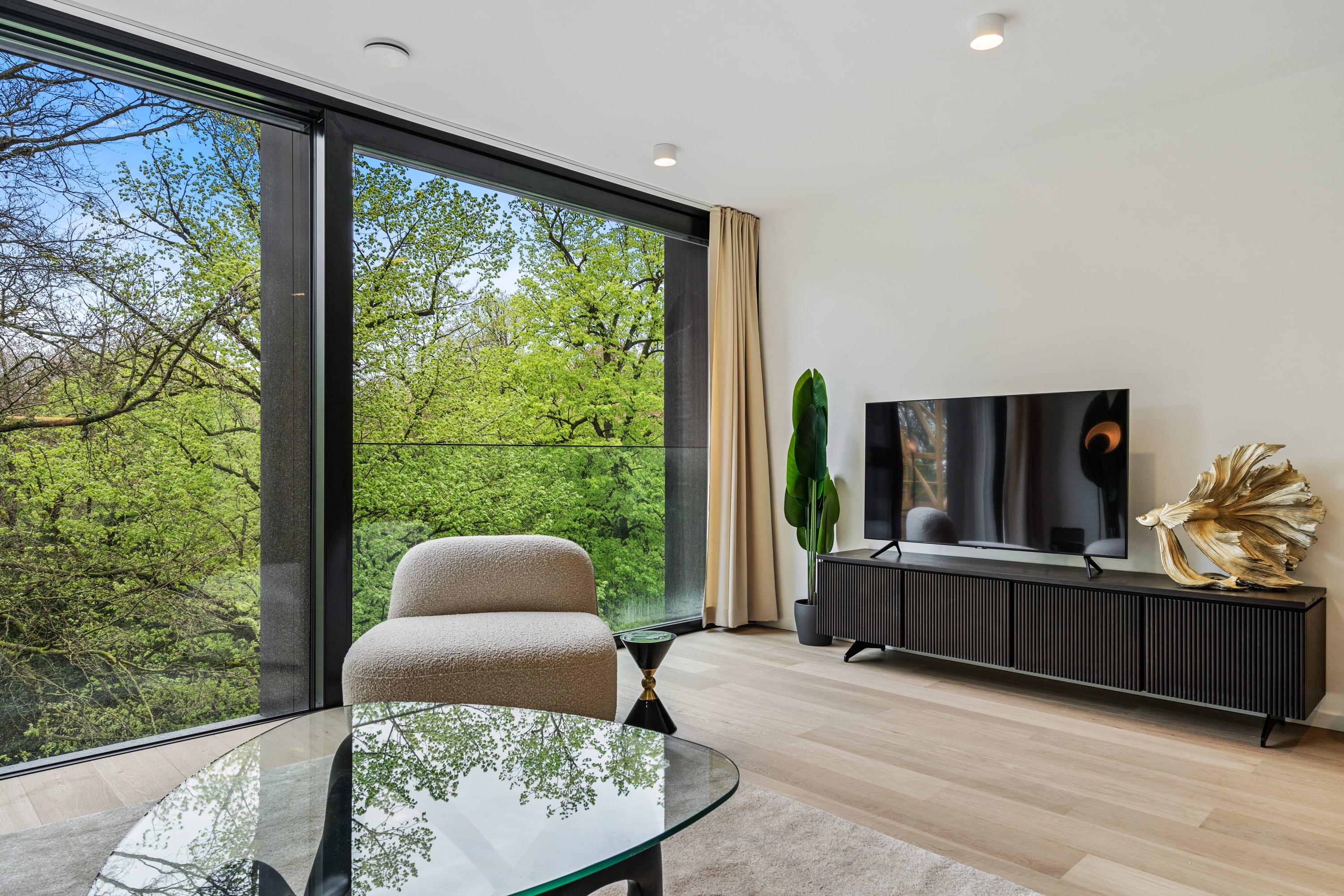 Unwind with your favorite shows in our modern living room, boasting stunning nature views.