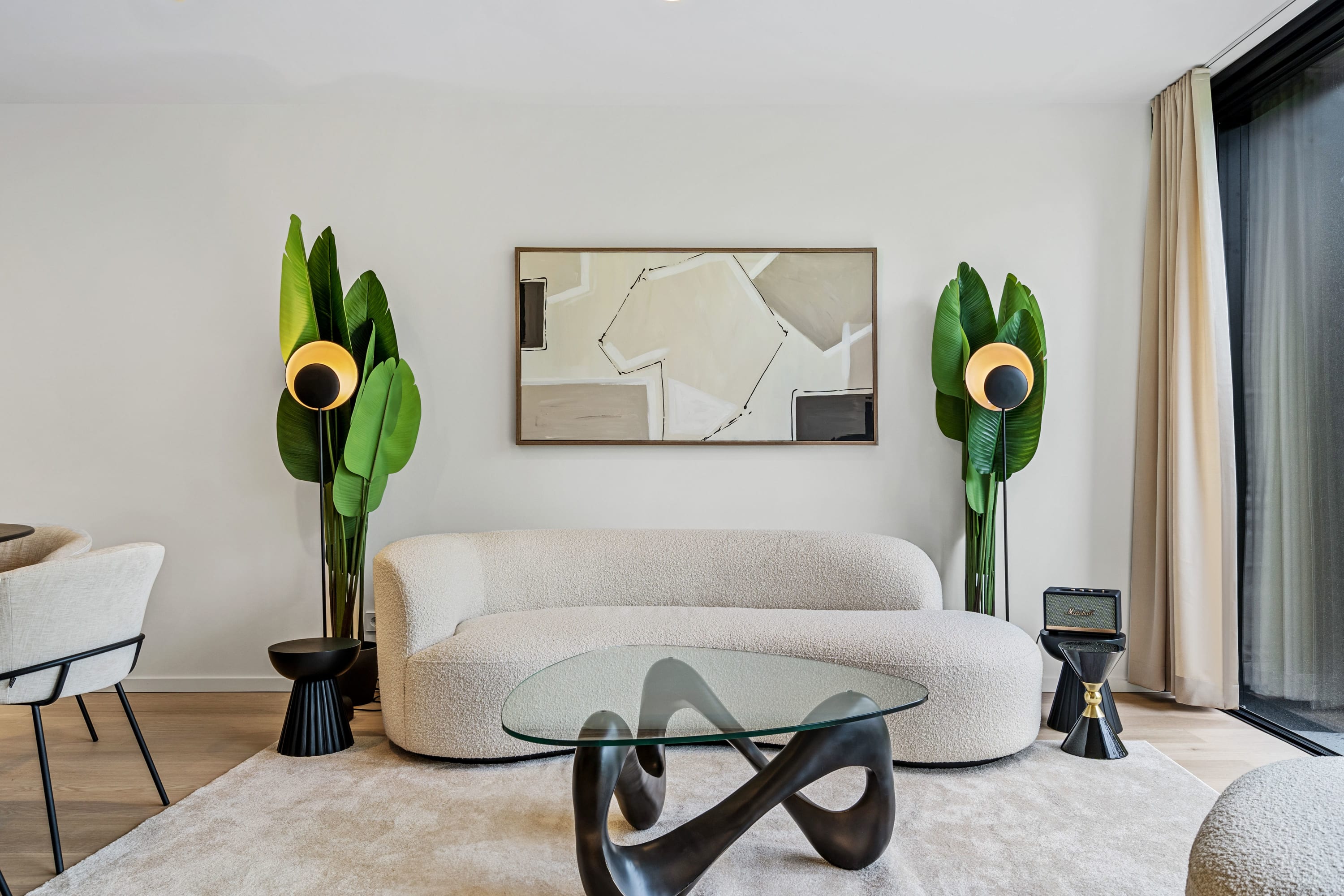Lounge in luxury, surrounded by curated art and lush green accents.