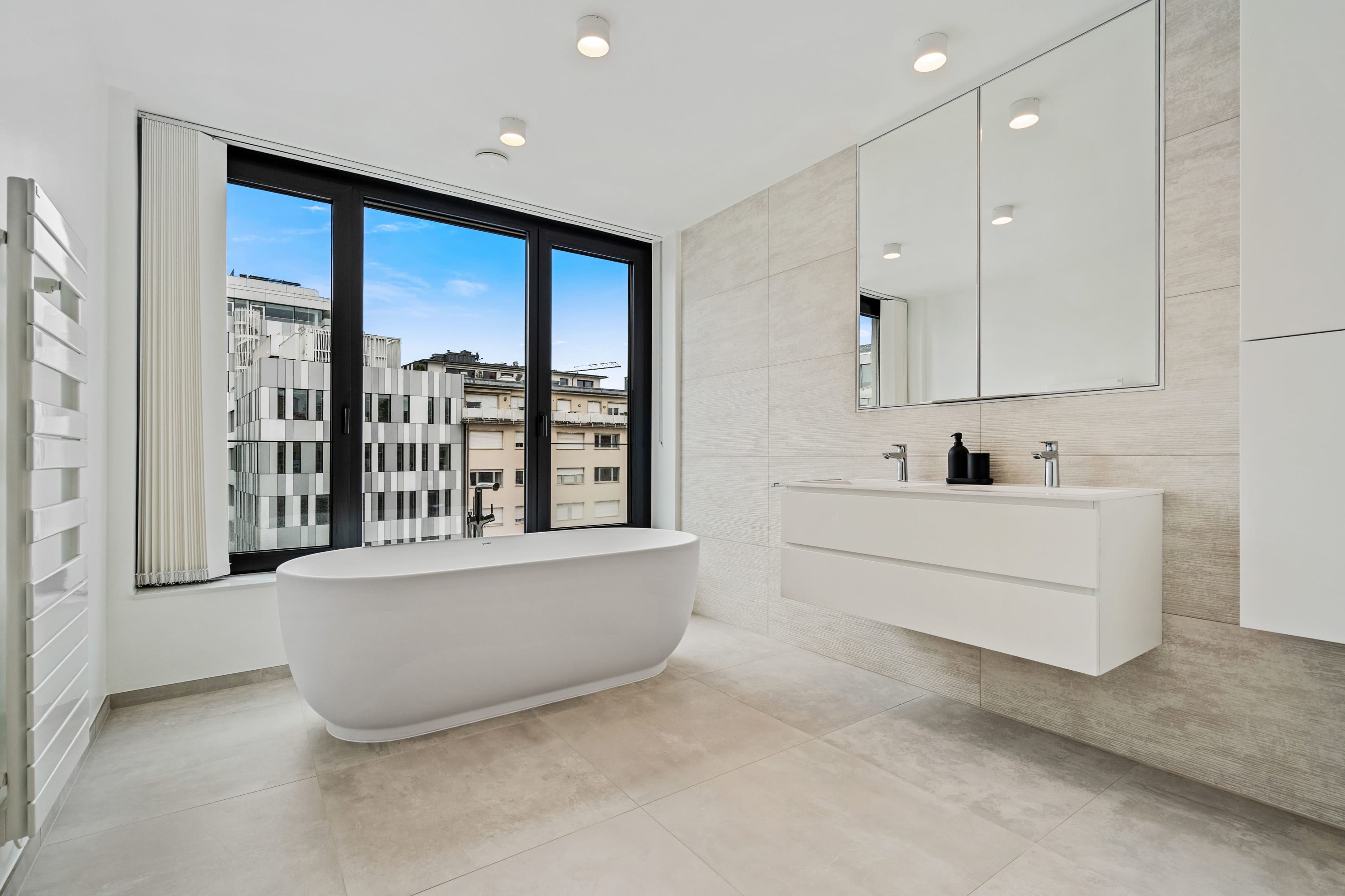 Indulge in skyline views while soaking in our luxurious freestanding tub.