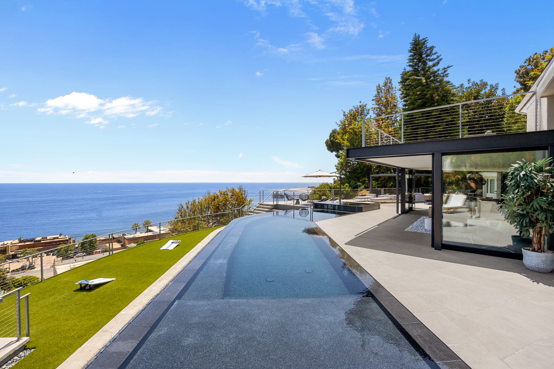 Dive into relaxation in the sparkling infinity pool, offering sweeping views of the Santa Monica Bay and Malibu Pier.