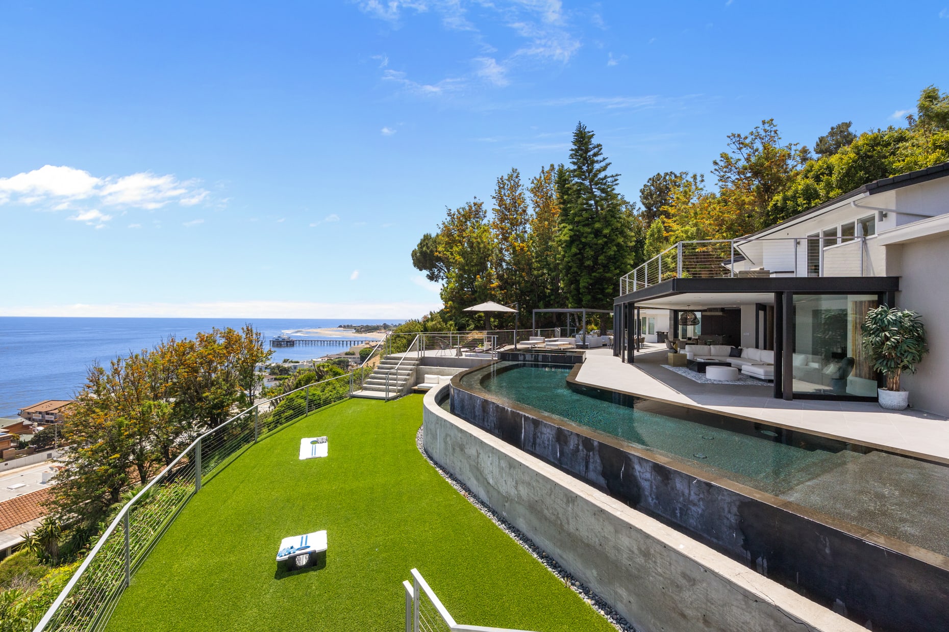 Challenge friends and family to a friendly game of cornhole on the expansive lawn, surrounded by stunning ocean vistas.