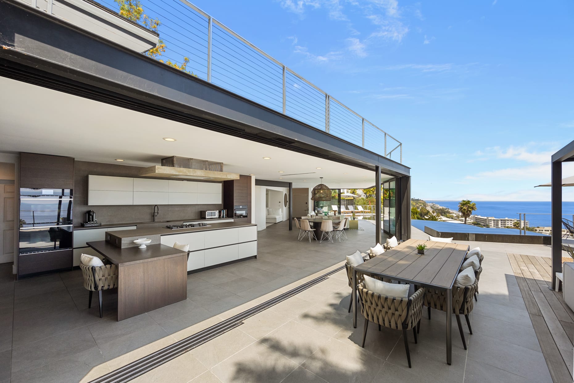 The open layout seamlessly integrates the kitchen, dining, and living spaces for a cohesive feel.