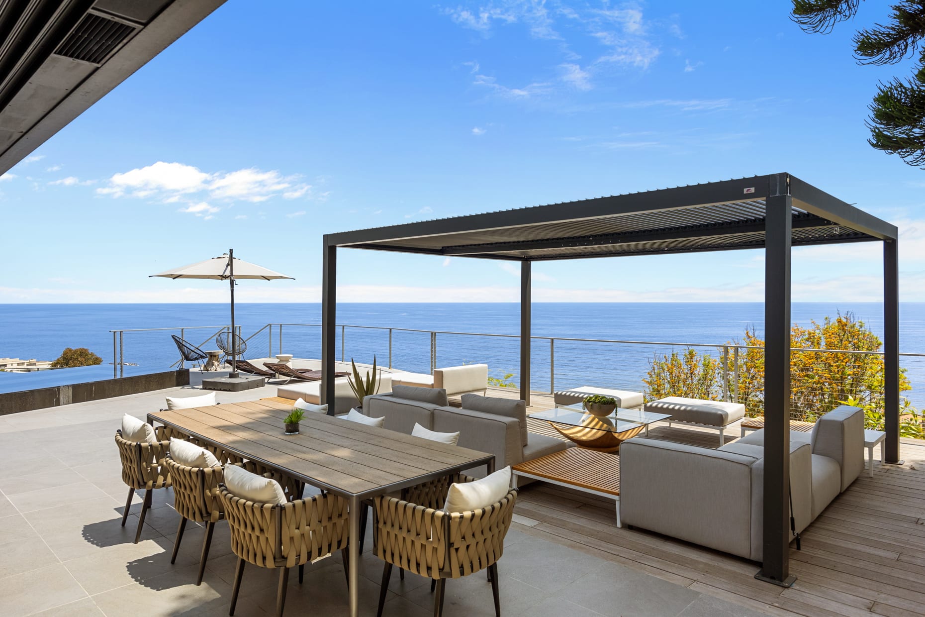 Experience the beauty of coastal living while dining outdoors, with comfortable seating and a picturesque backdrop.