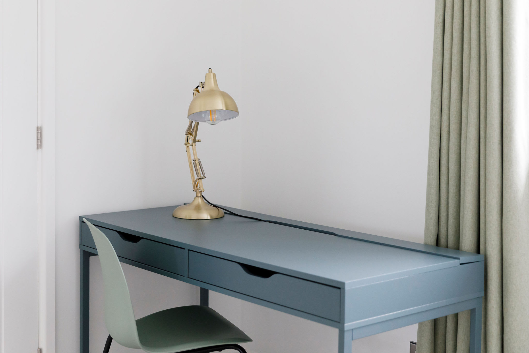 Elegant desk with a gold lamp, perfect for a home office setup