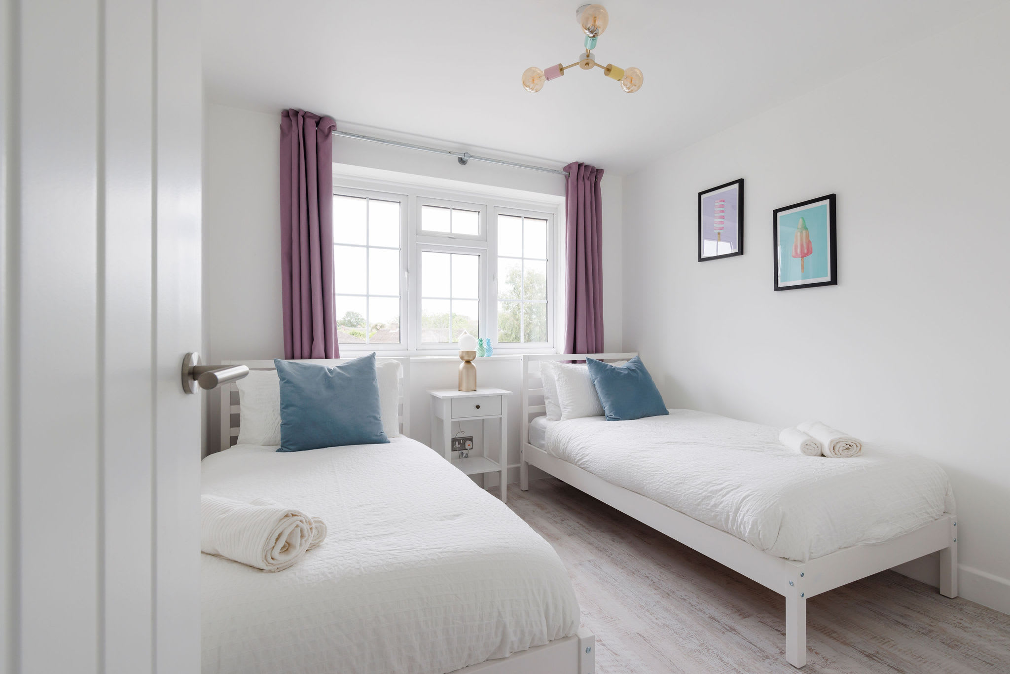 Twin bedroom with bright decor and comfortable bedding