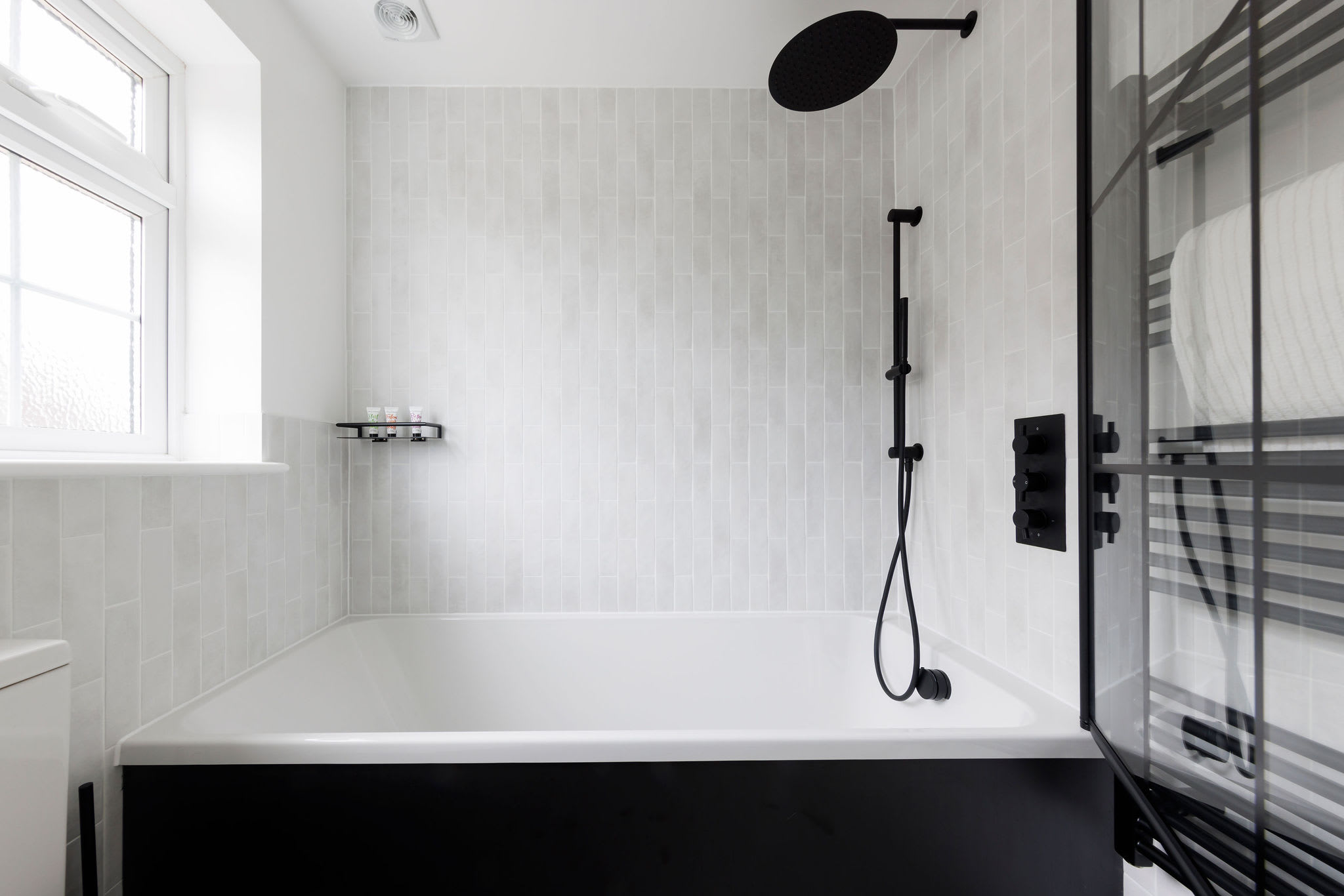 Contemporary bathtub with black fixtures and a minimalist design for a spa-like experience
