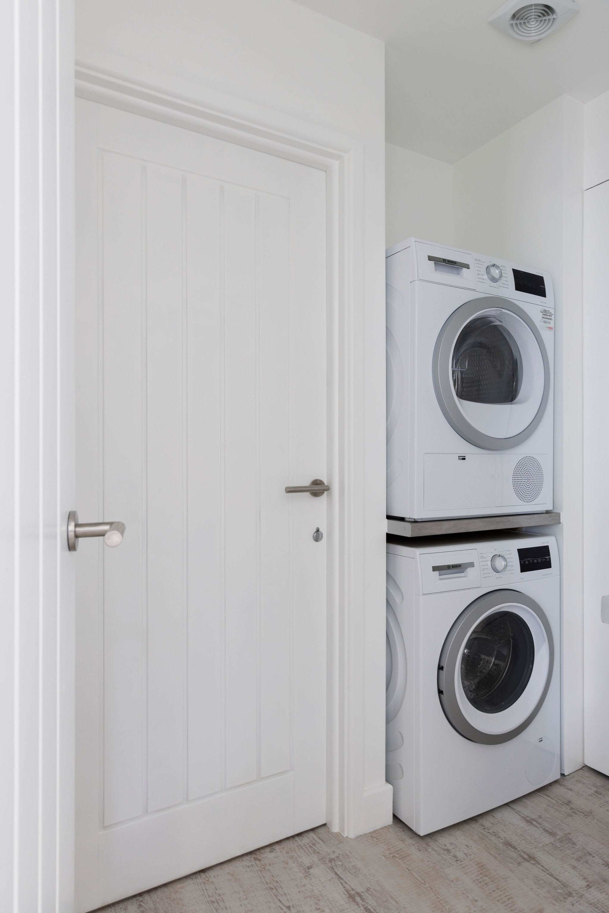 Compact laundry area with a stacked washer and dryer for convenience