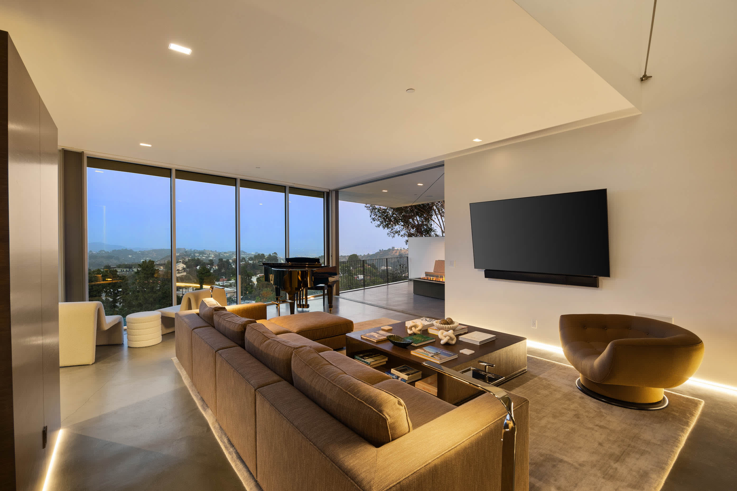 Living room exuding opulence with its refined decor and panoramic glass walls.