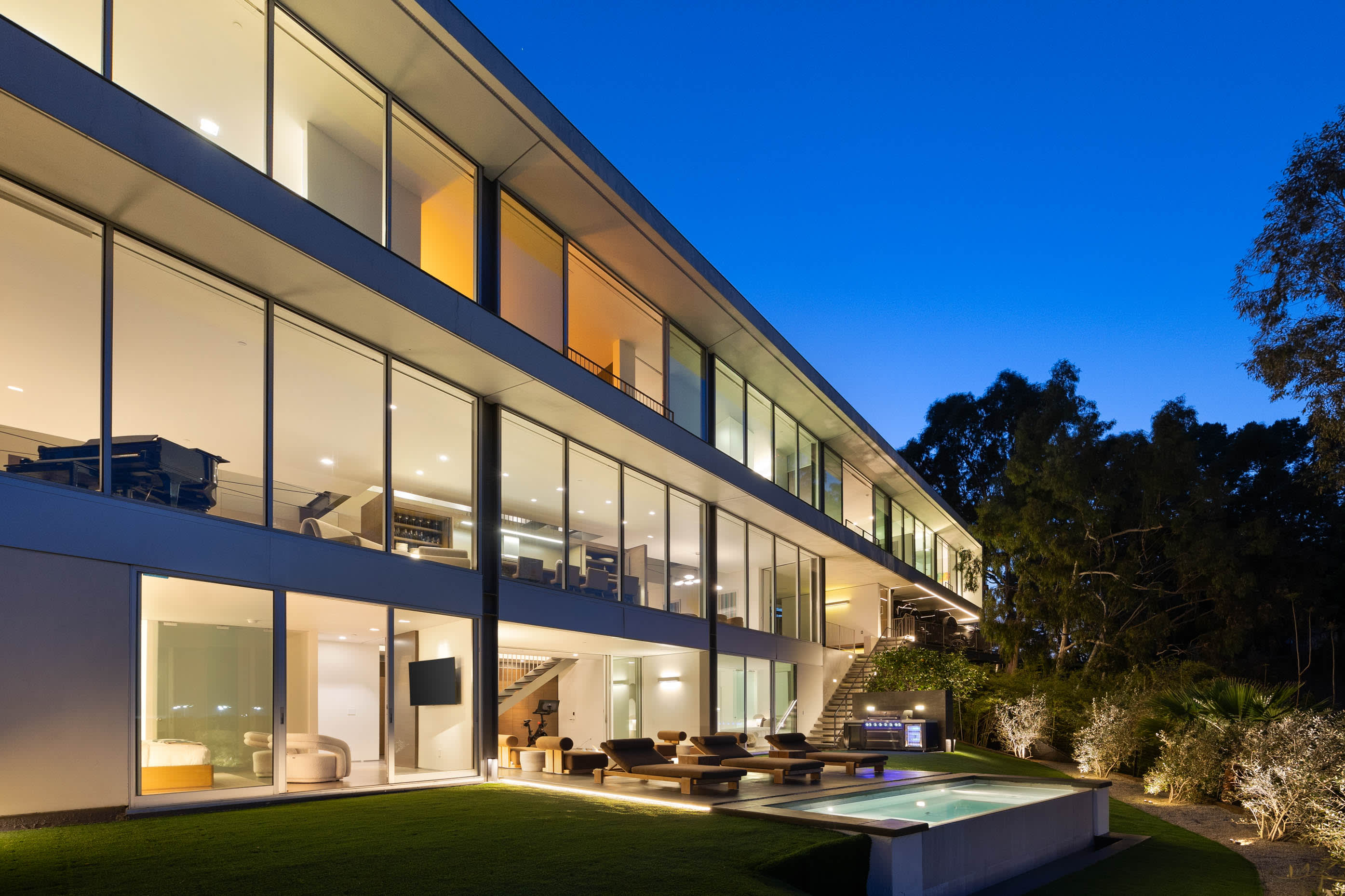 Stunning three-story architectural masterpiece with expansive glass walls.