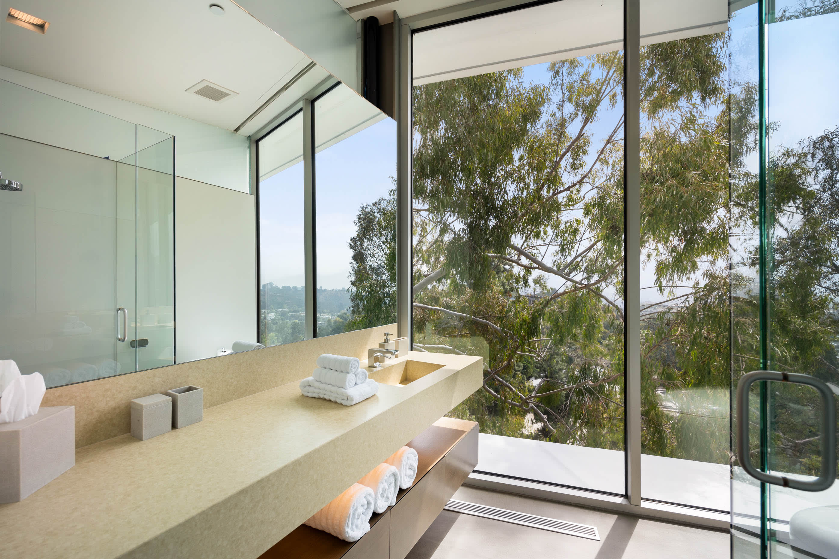 Lavish bathroom with high-end finishes and Kohler Karing smart toilets.