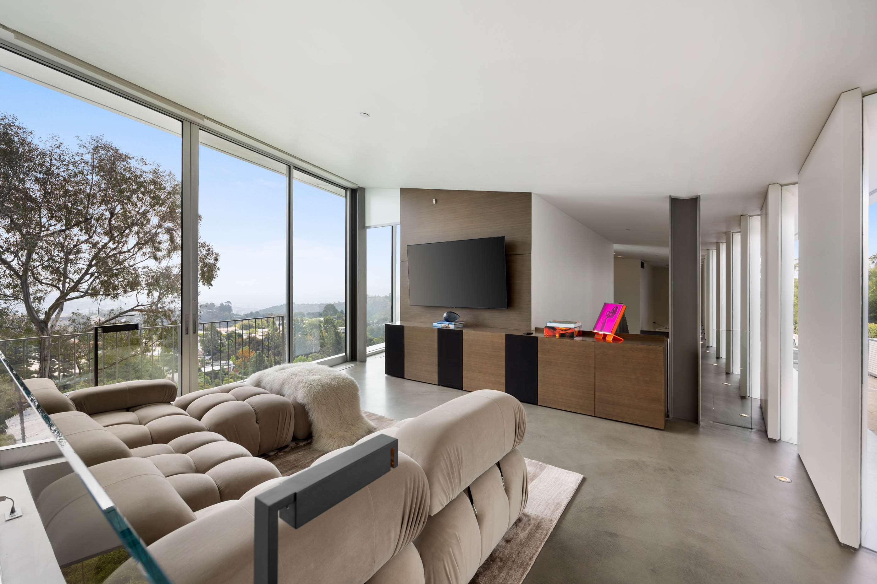 Floor-to-ceiling glass doors provide a captivating view, seamlessly blending indoor elegance with the beauty of natural light.