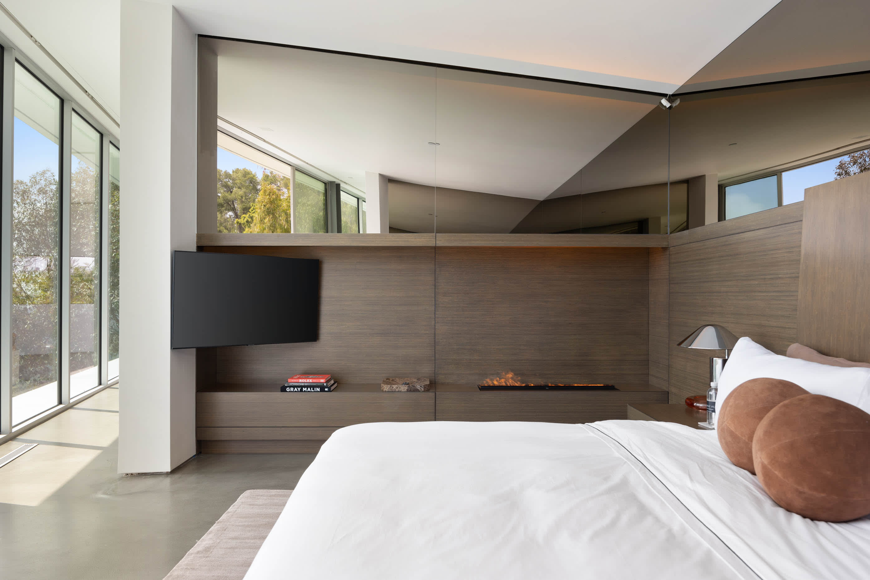 Lavish bedroom with a huge bed and floor-to-ceiling windows, providing spectacular views.