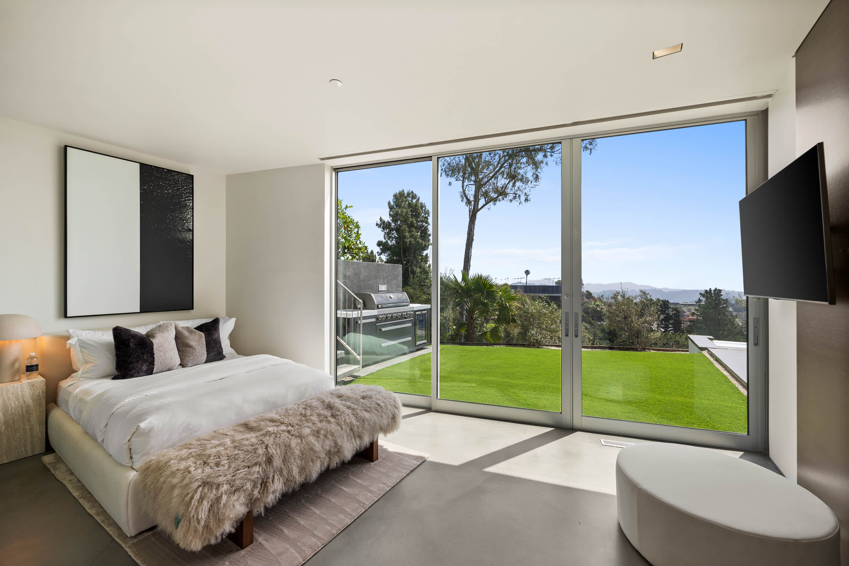 Luxurious bedroom with direct access to the private pool, offering an exclusive indoor-outdoor living experience.