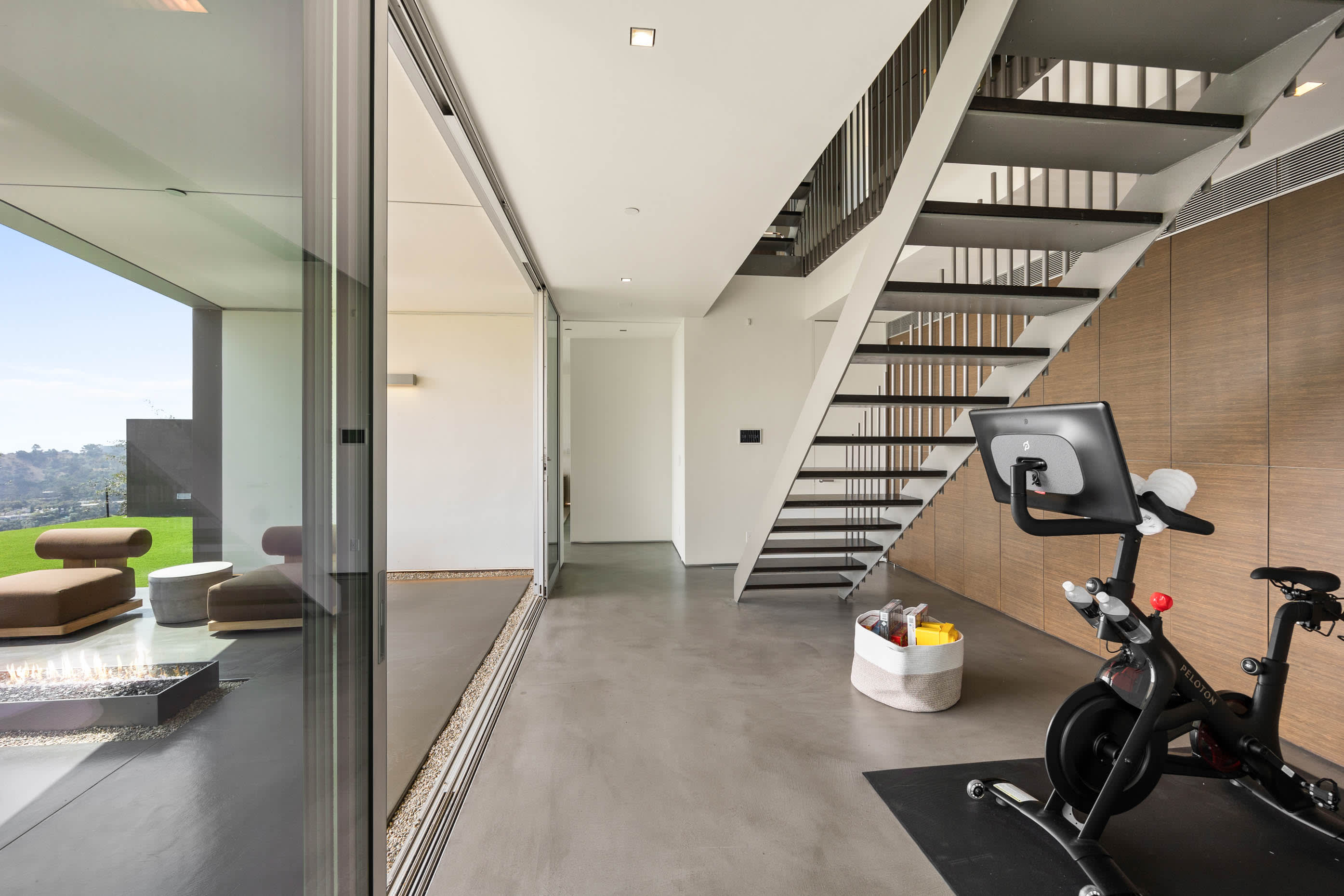 Exercise space with top-tier equipment, seamlessly blending fitness with poolside luxury and stunning vistas.