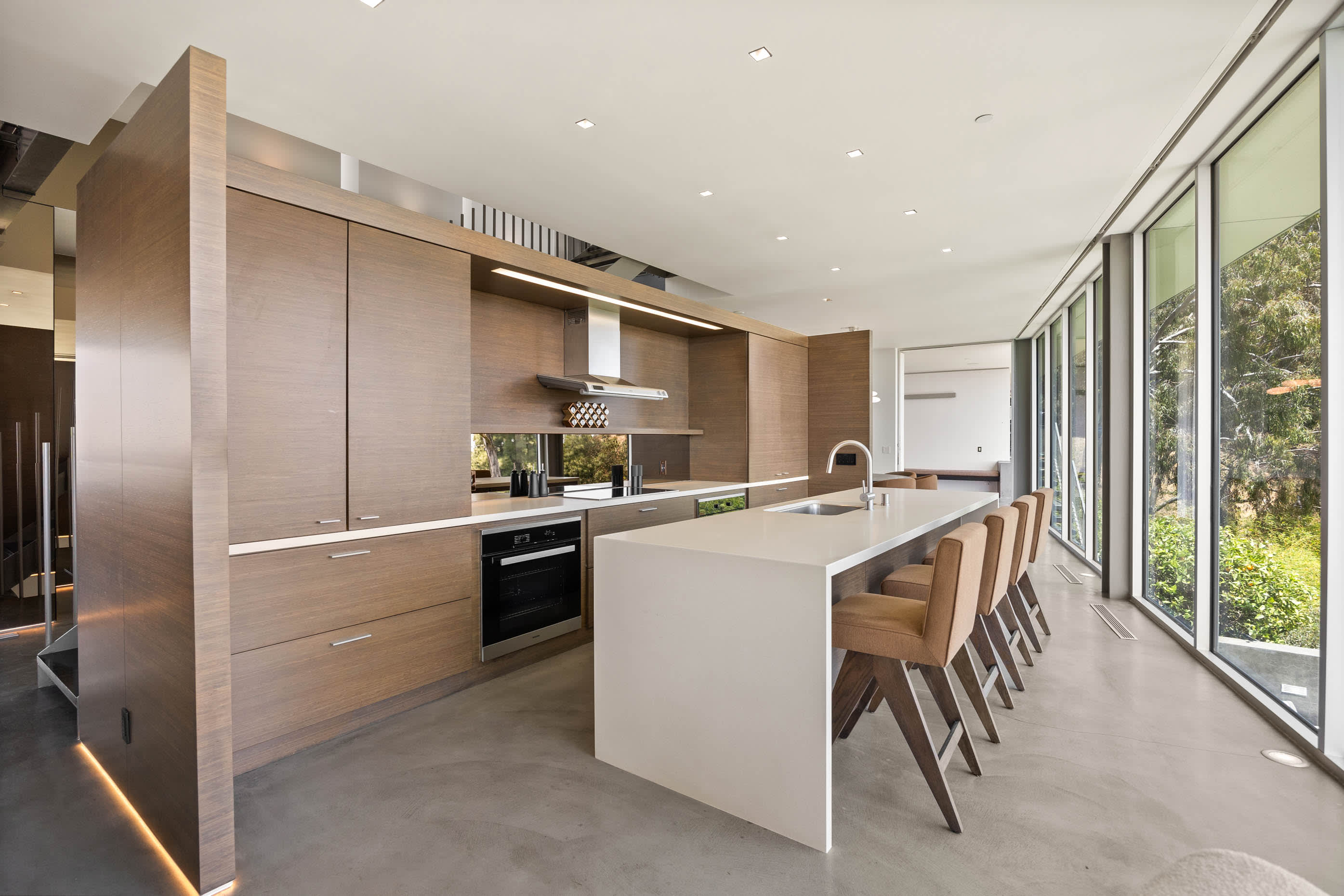 Gourmet kitchen equipped with top-tier Miele appliances, gleaming marble countertops, and custom cabinetry.