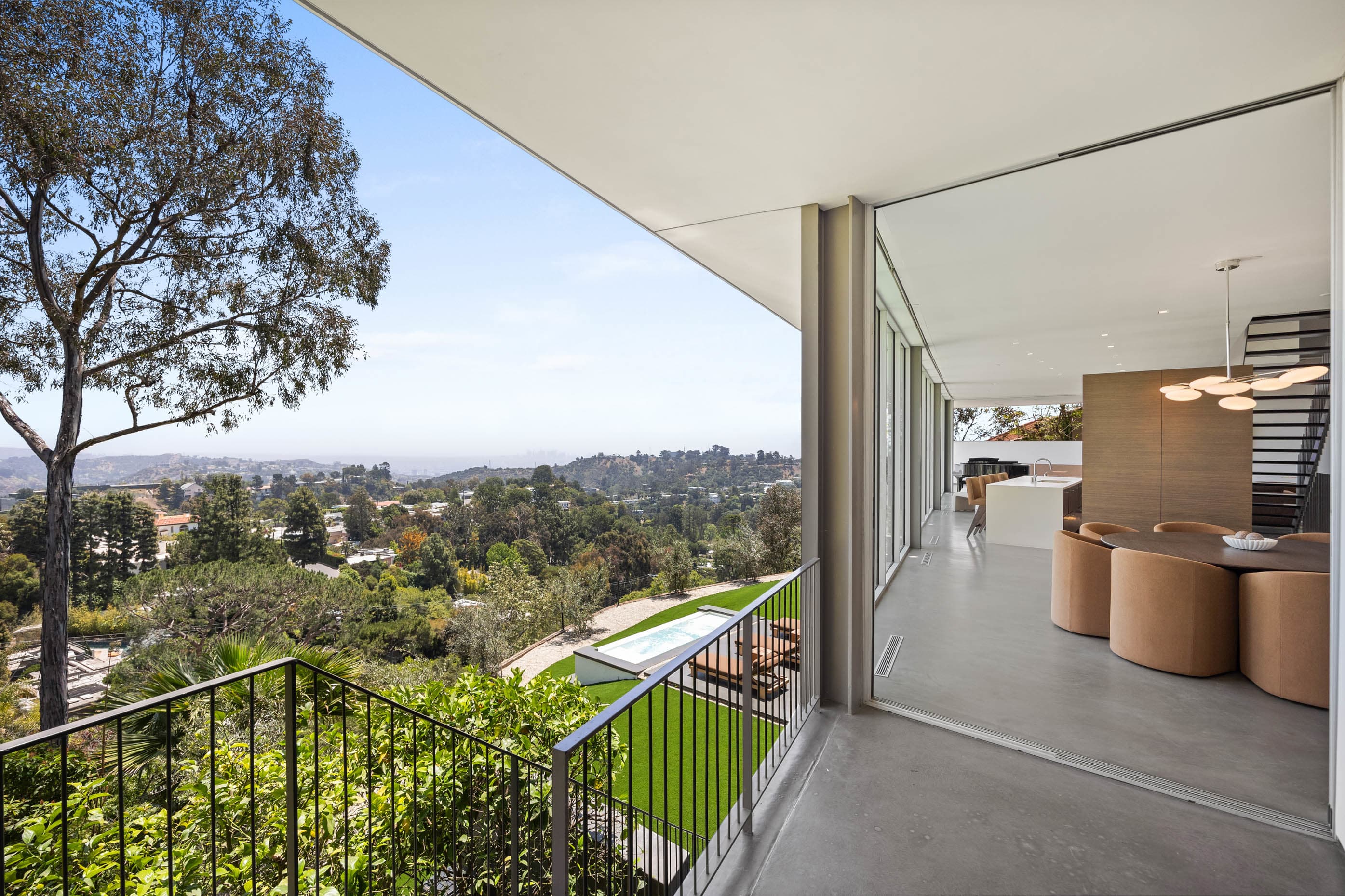 Expansive floor-to-ceiling glass walls, creating a seamless flow and an atmosphere of expansive luxury.