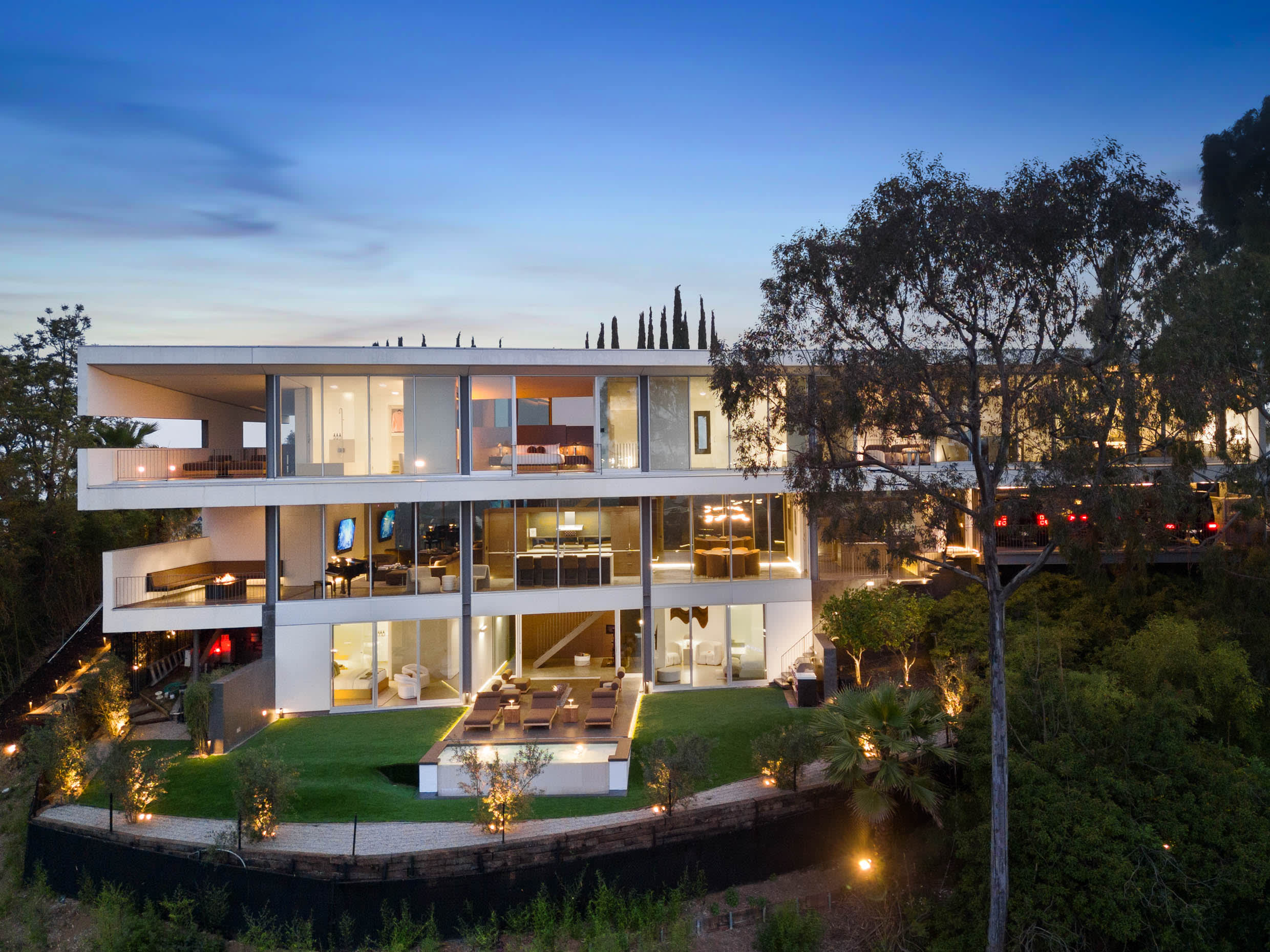 Architectural masterpiece featuring floor-to-ceiling glass walls with stunning city and natural views.