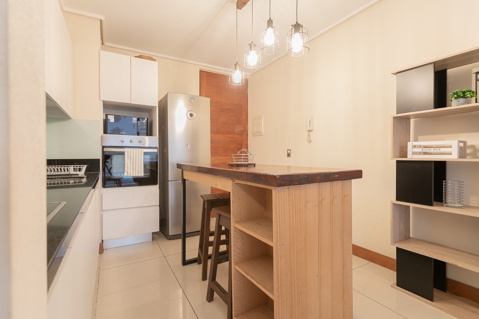 Chic kitchen with modern appliances and a cozy dining island, ideal for intimate meals in your private space.