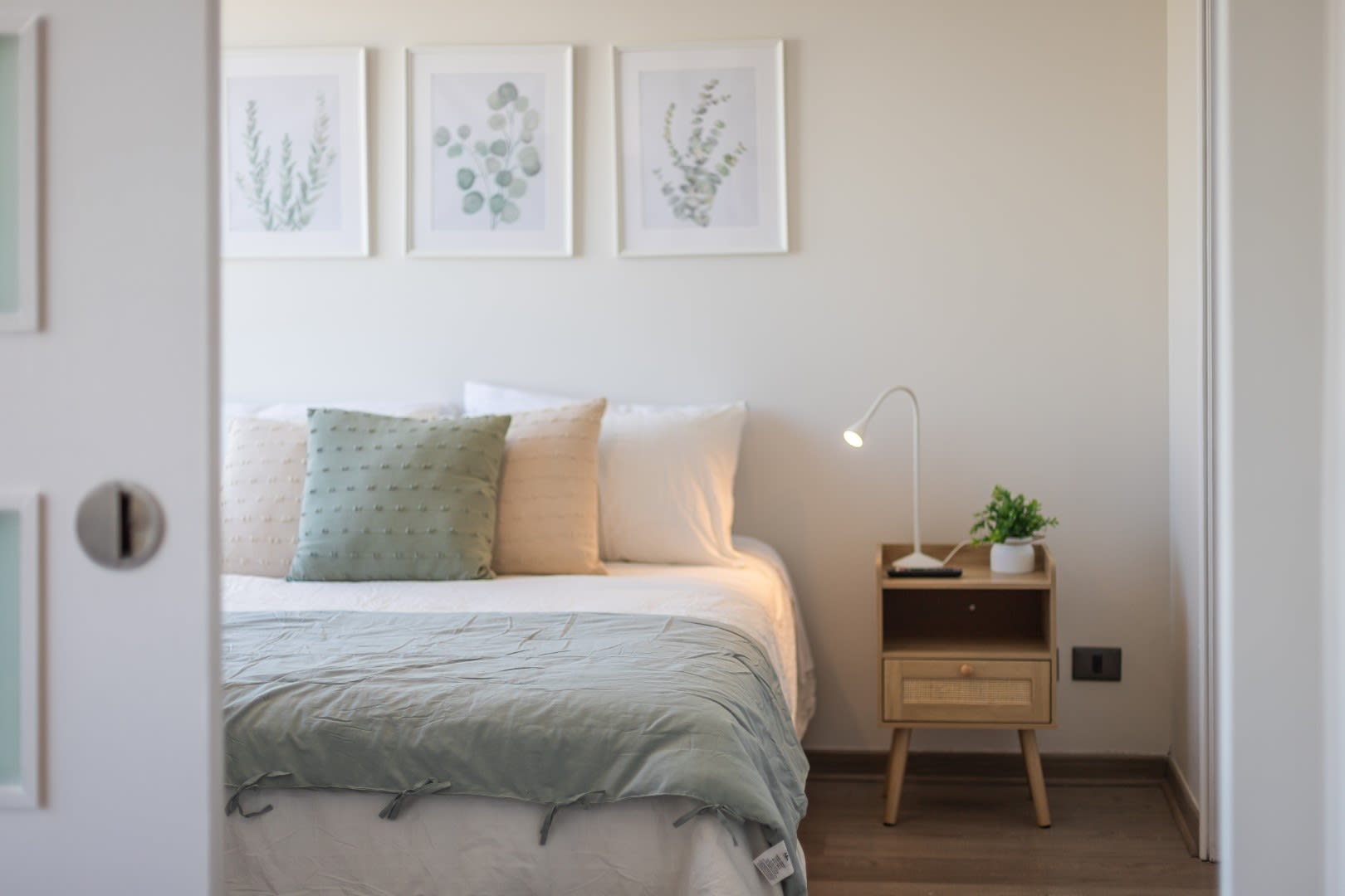 Relax in this serene and stylish bedroom with natural light and calming decor.