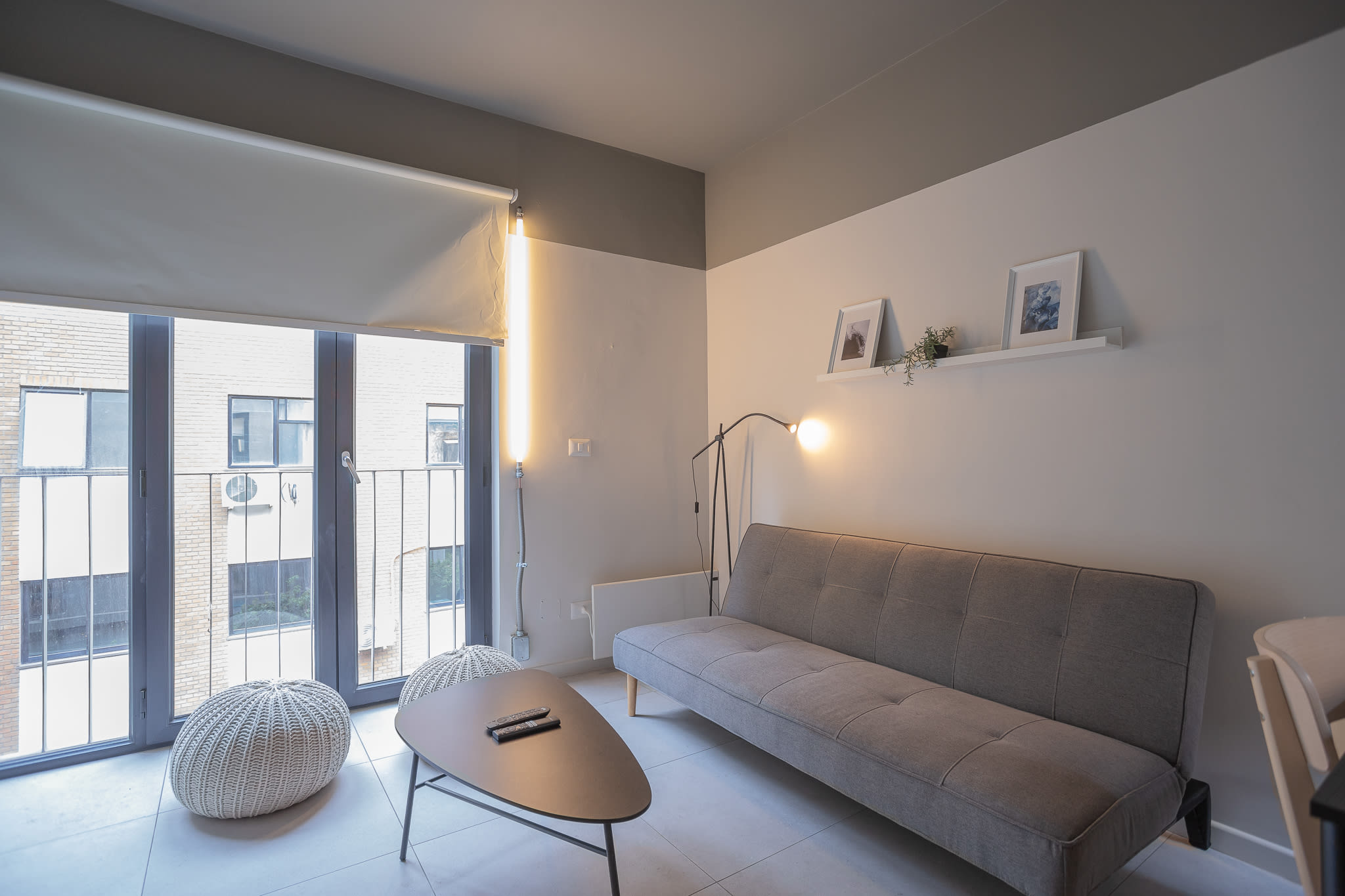 Cozy modern living room with stylish decor and ample natural light, perfect for relaxing after a day of exploring.