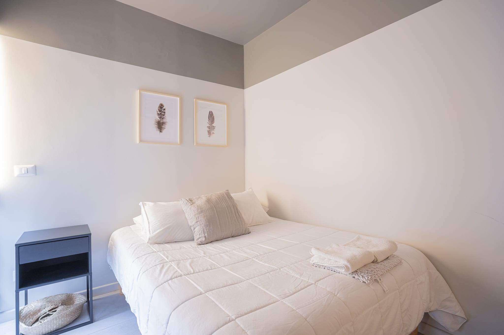 Cozy bedroom retreat with soft natural light and minimalist decor, perfect for a restful night's sleep.