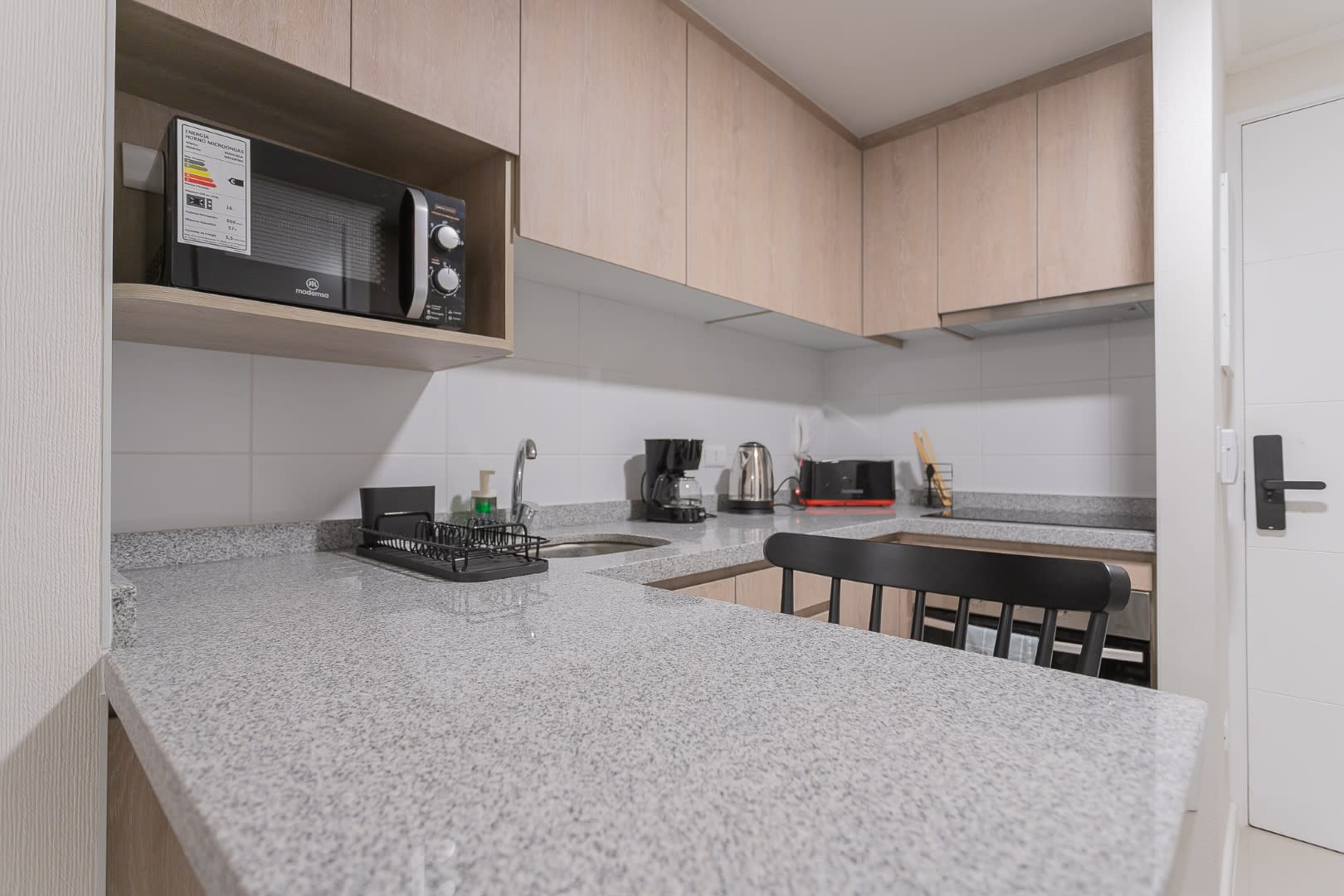 Modern kitchen with sleek appliances and ample counter space, perfect for preparing your favorite meals.