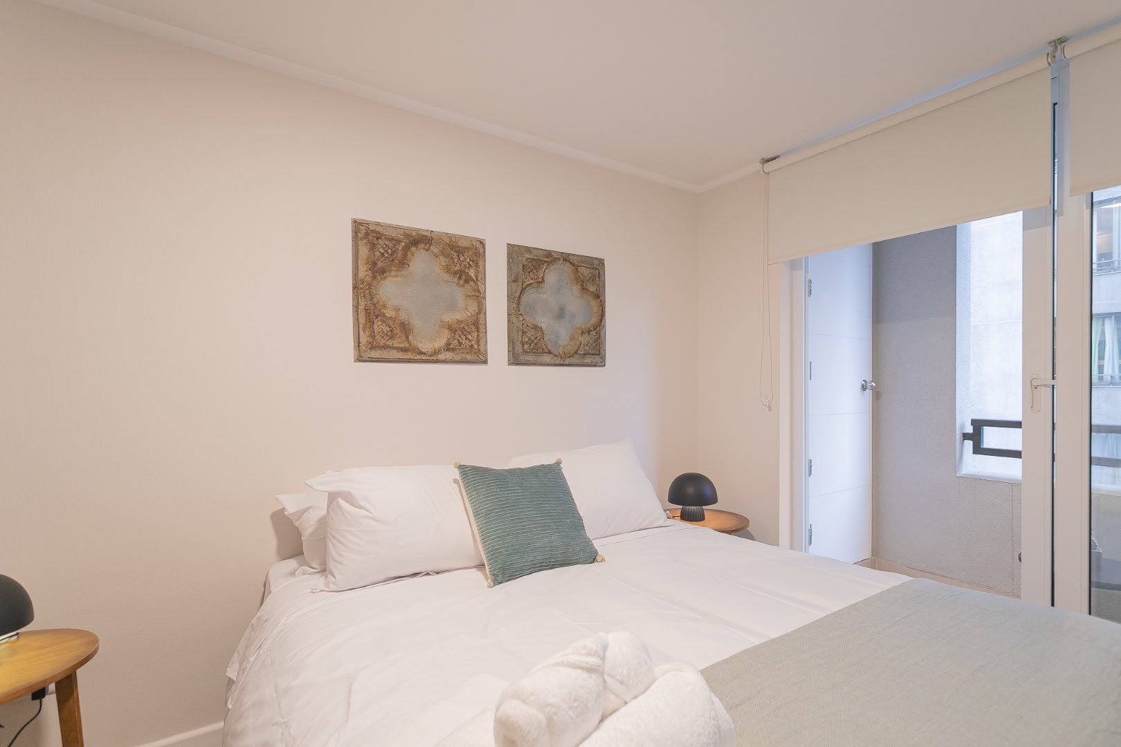 Relax in this serene bedroom with a private balcony, perfect for unwinding after a day of exploring.