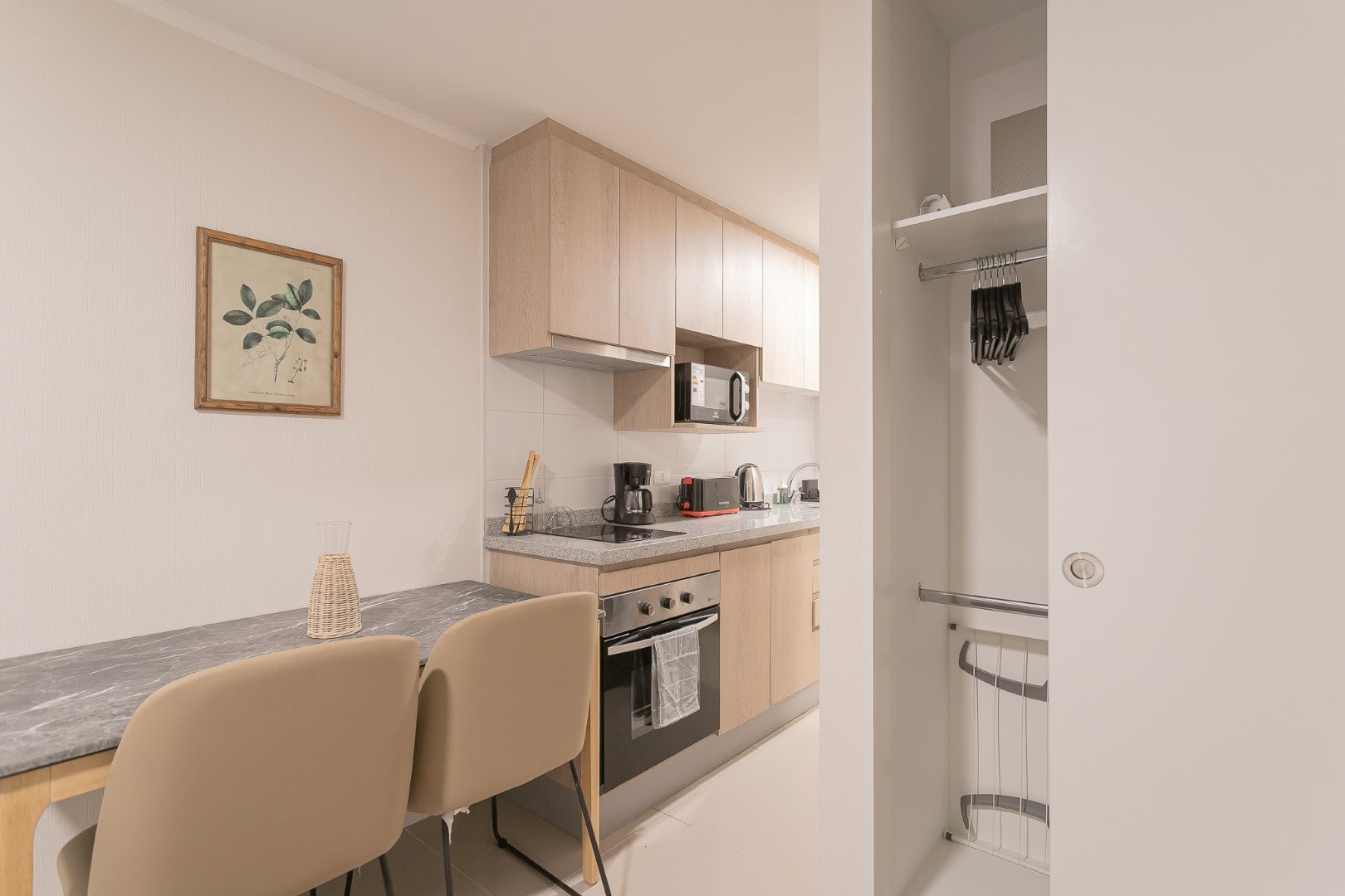 Modern compact kitchen with all essentials for a cozy meal, perfect for a quick breakfast or a relaxing dinner after exploring the city.