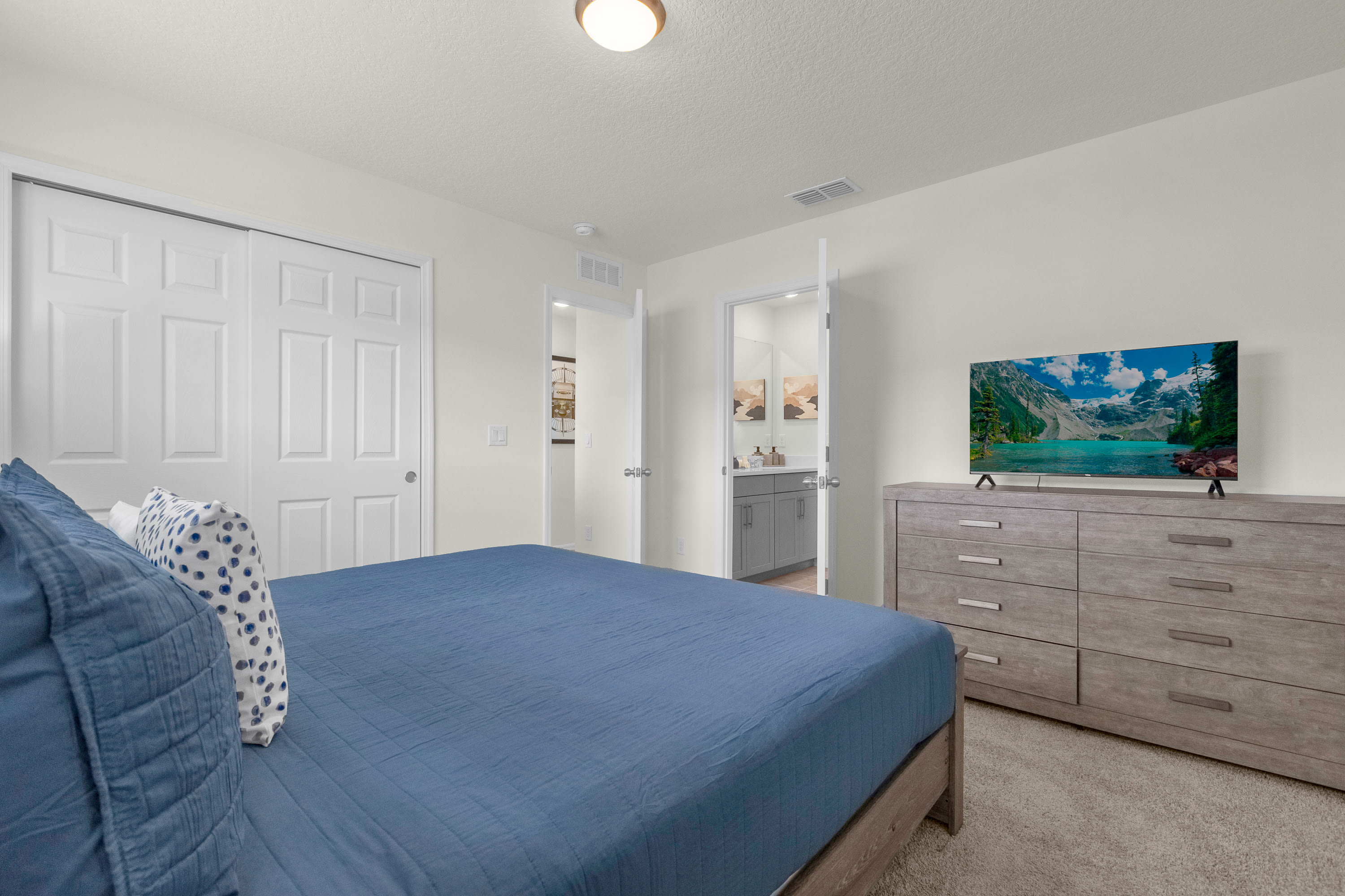 Comfortable Queen Bedroom With Stylish Decor And Natural Light