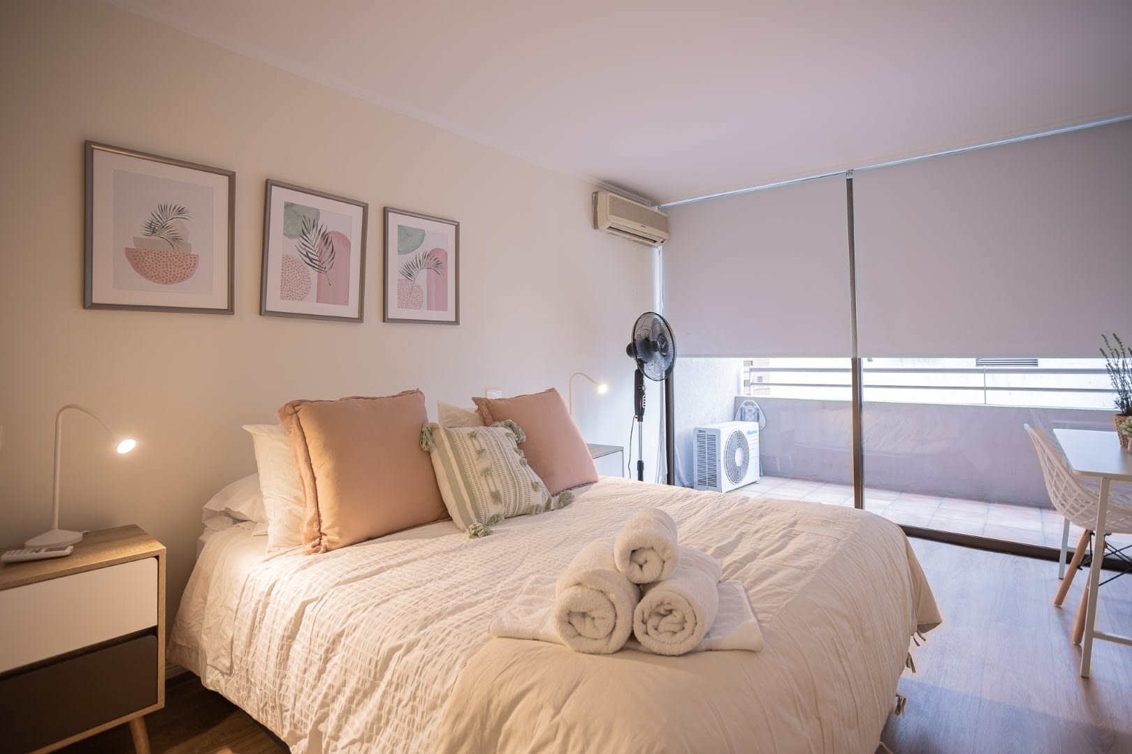 Relax in this tranquil bedroom with soft pastel decor and enjoy the natural light from the large window. Perfect for a peaceful stay.