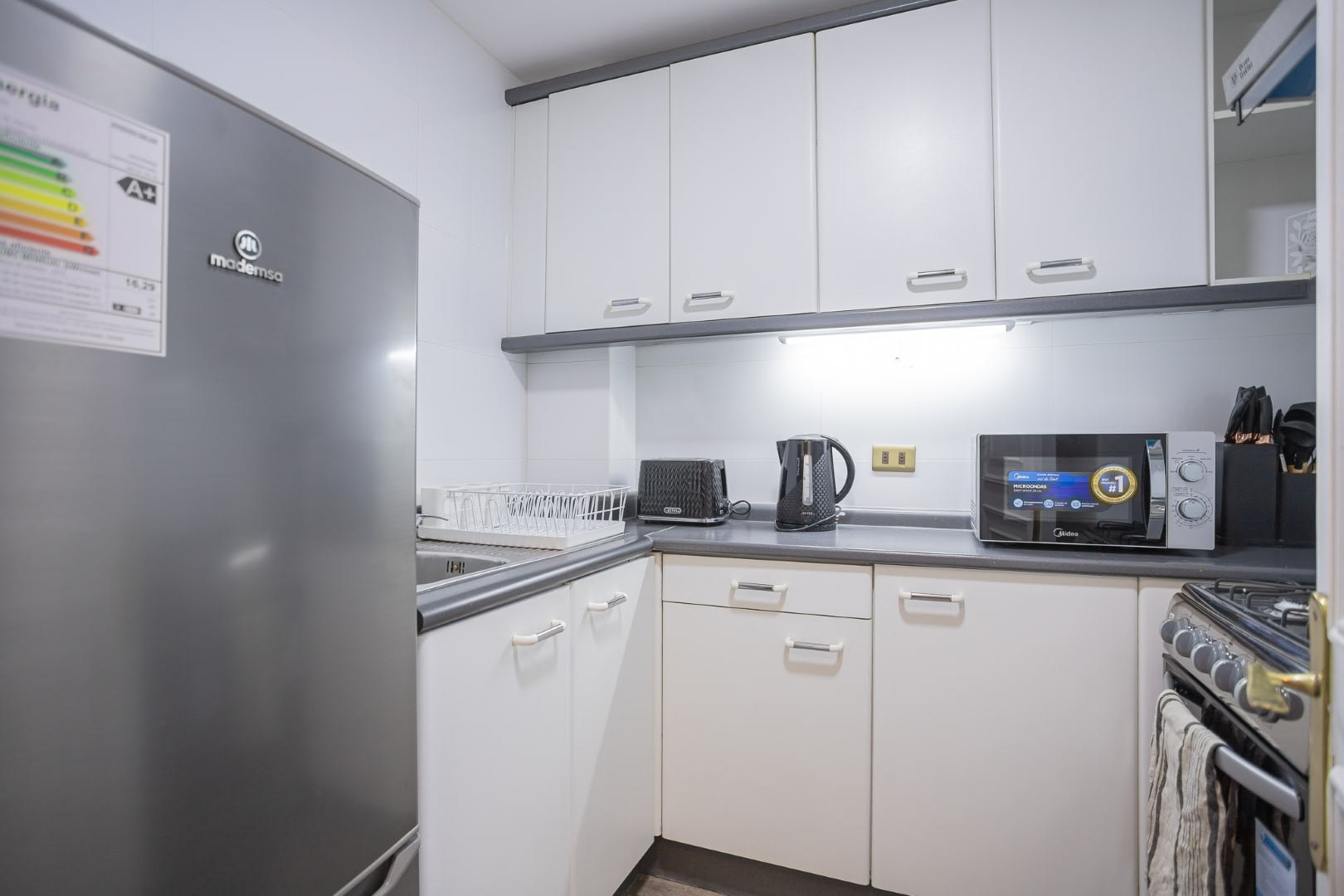 Modern and fully-equipped kitchen with sleek appliances, perfect for preparing meals during your stay.