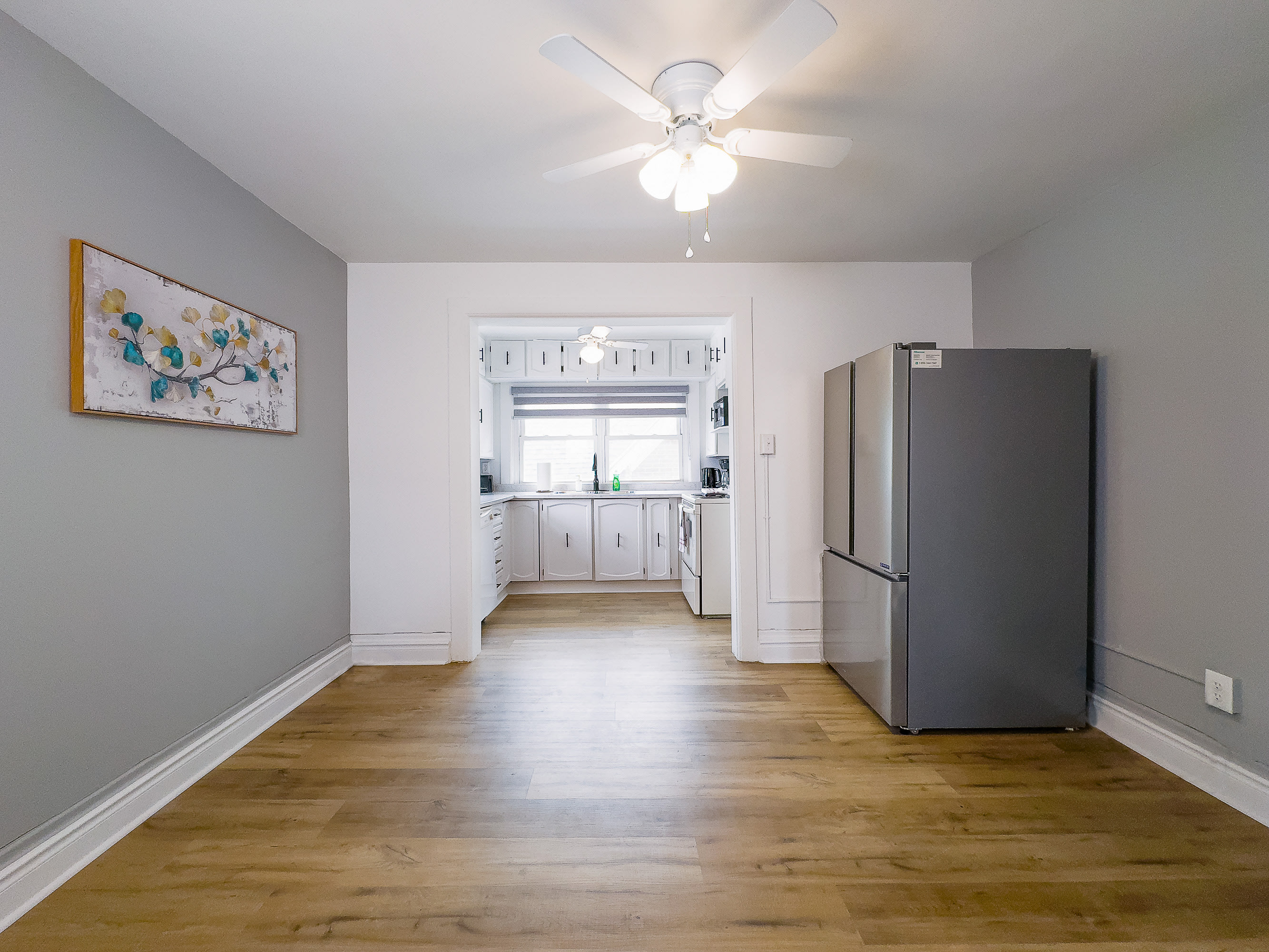 A Bright And Spacious Dining Area Leading Into A Modern Kitchen
