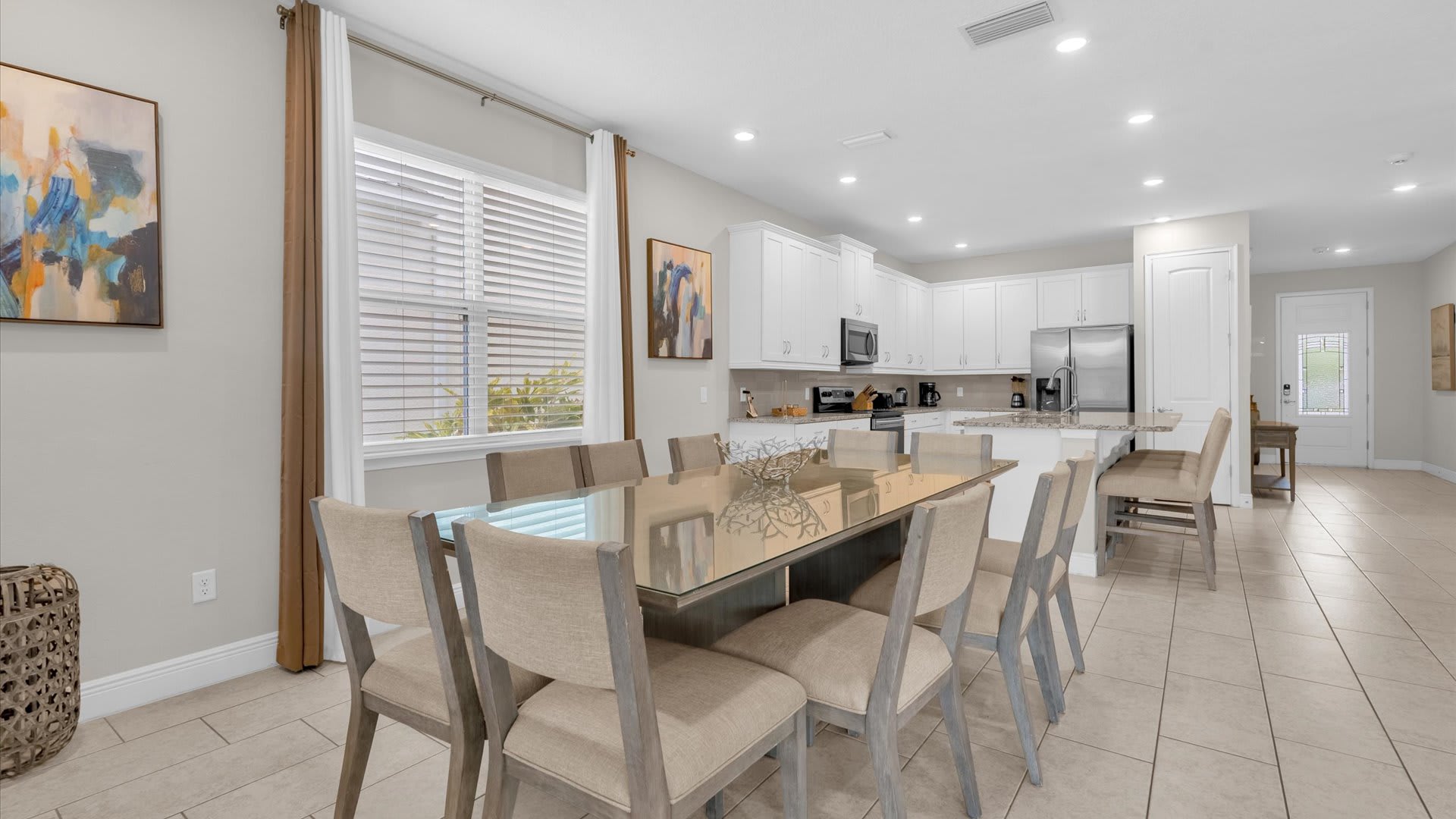 Elegant dining space perfect for family gatherings, featuring a modern kitchen and ample seating for memorable meals.