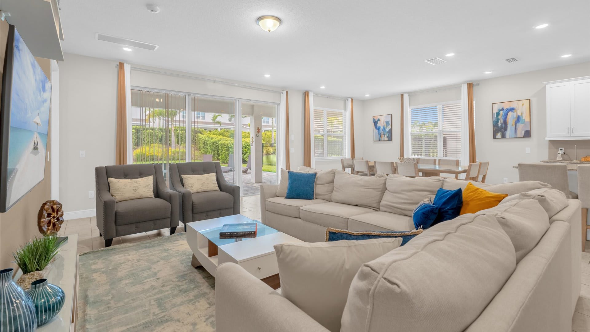 Relax in this spacious living room with abundant natural light and a seamless flow to the outdoor patio, perfect for gatherings.