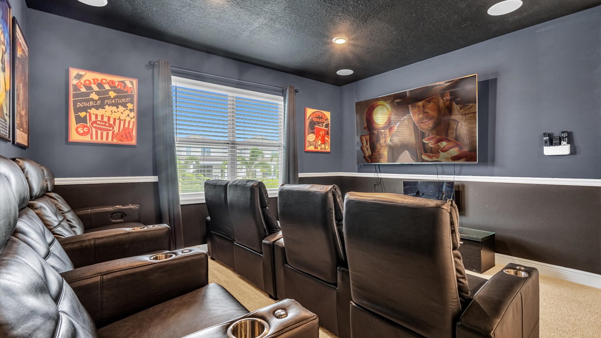 Enjoy movie nights in your private home theater with plush recliners and a big screen for the ultimate cinematic experience.