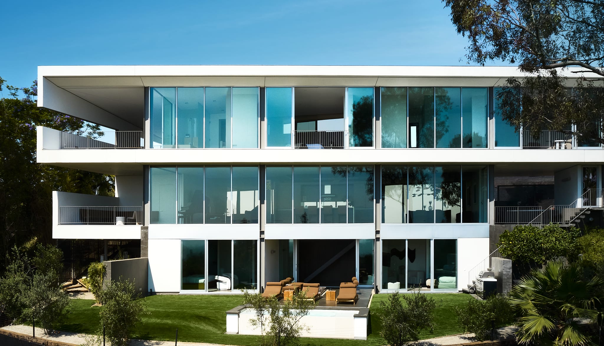 Experience the outdoor oasis, featuring a luxurious pool area surrounded by meticulously designed exterior spaces.