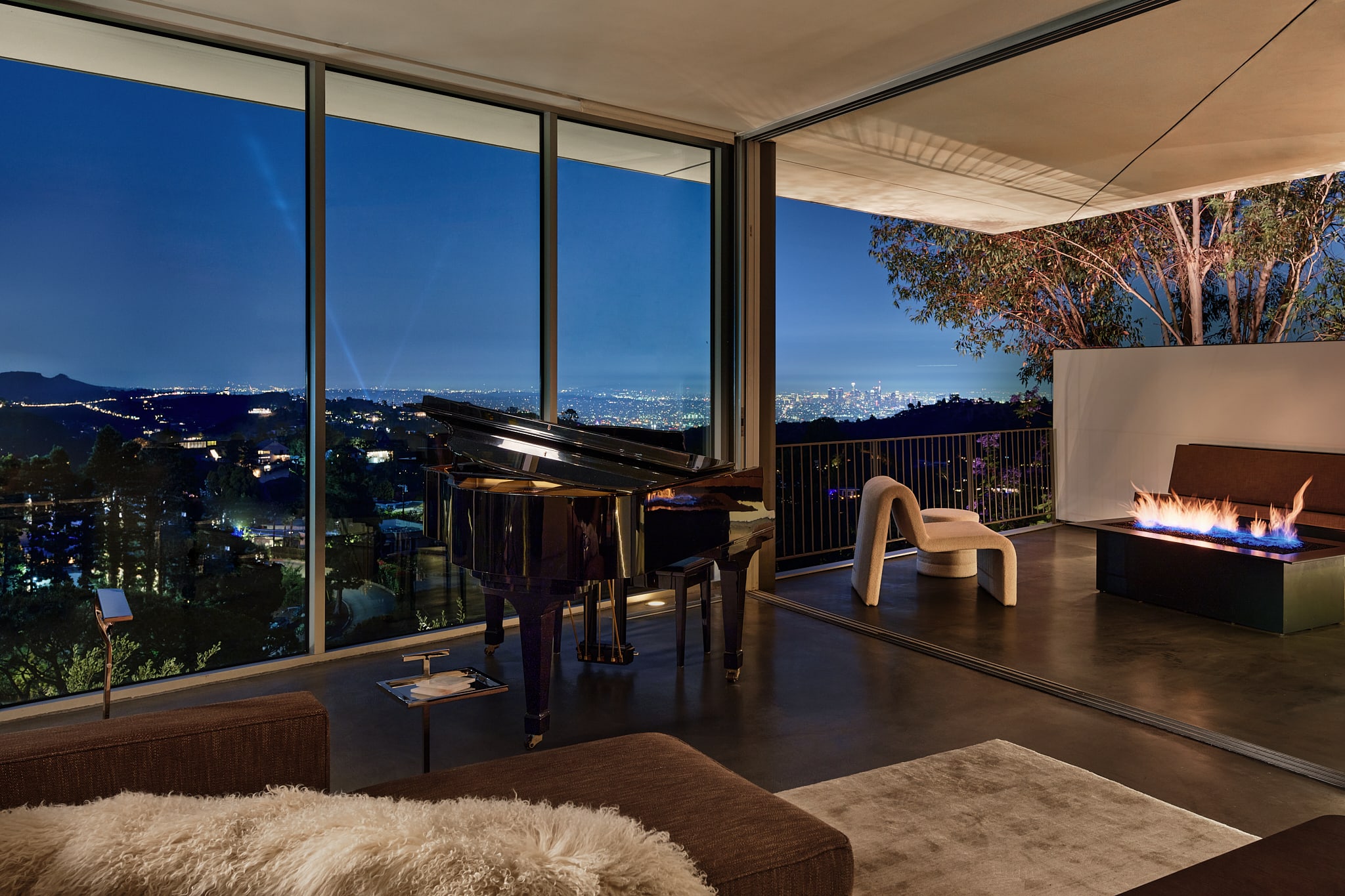 Enjoy the grand piano and elegant fire pit, all while taking in the expansive city views.